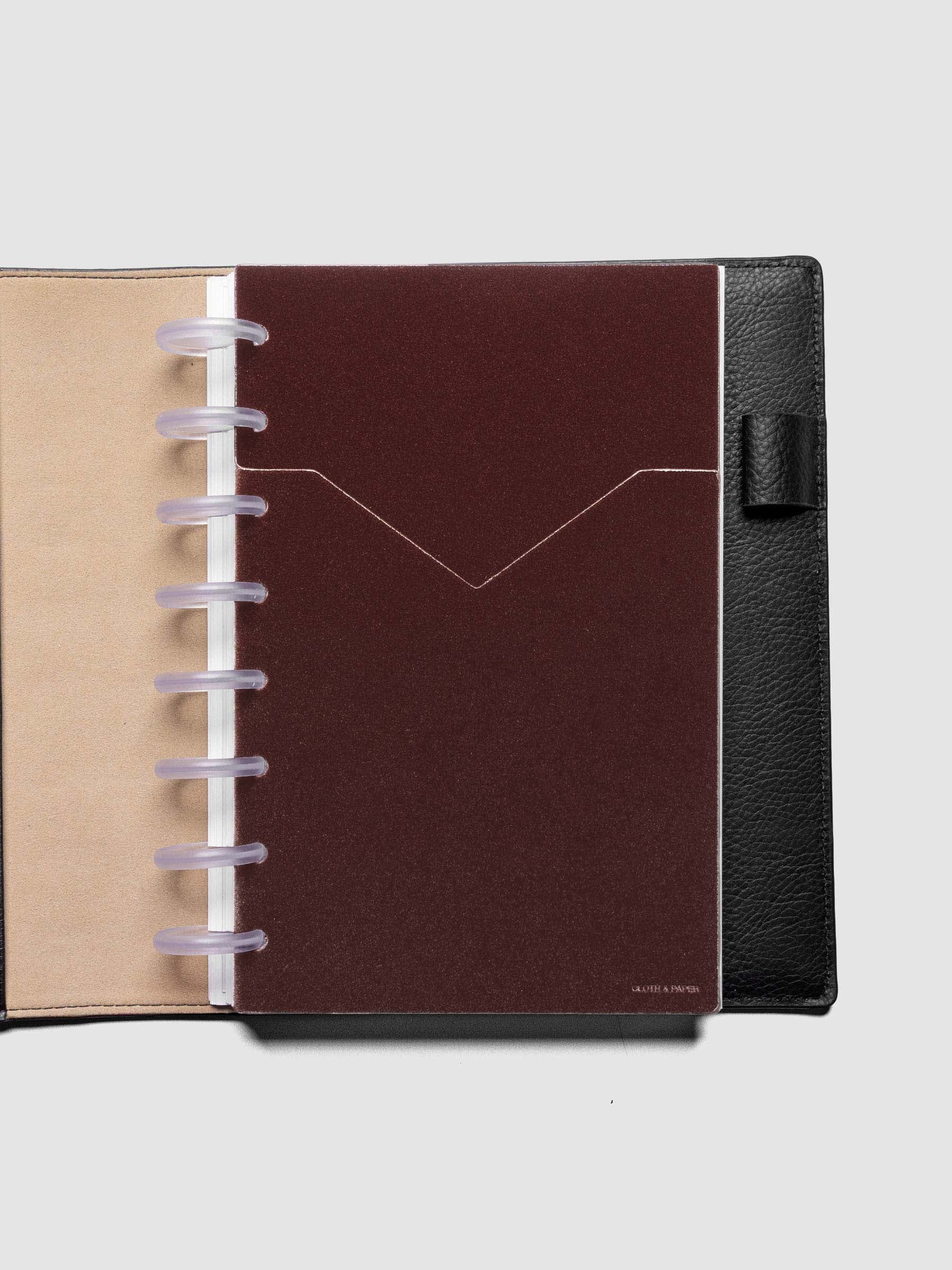 Velvet Pocket Folder in Bordeaux pre-punched for Half Letter planners shown in a black leather folio.