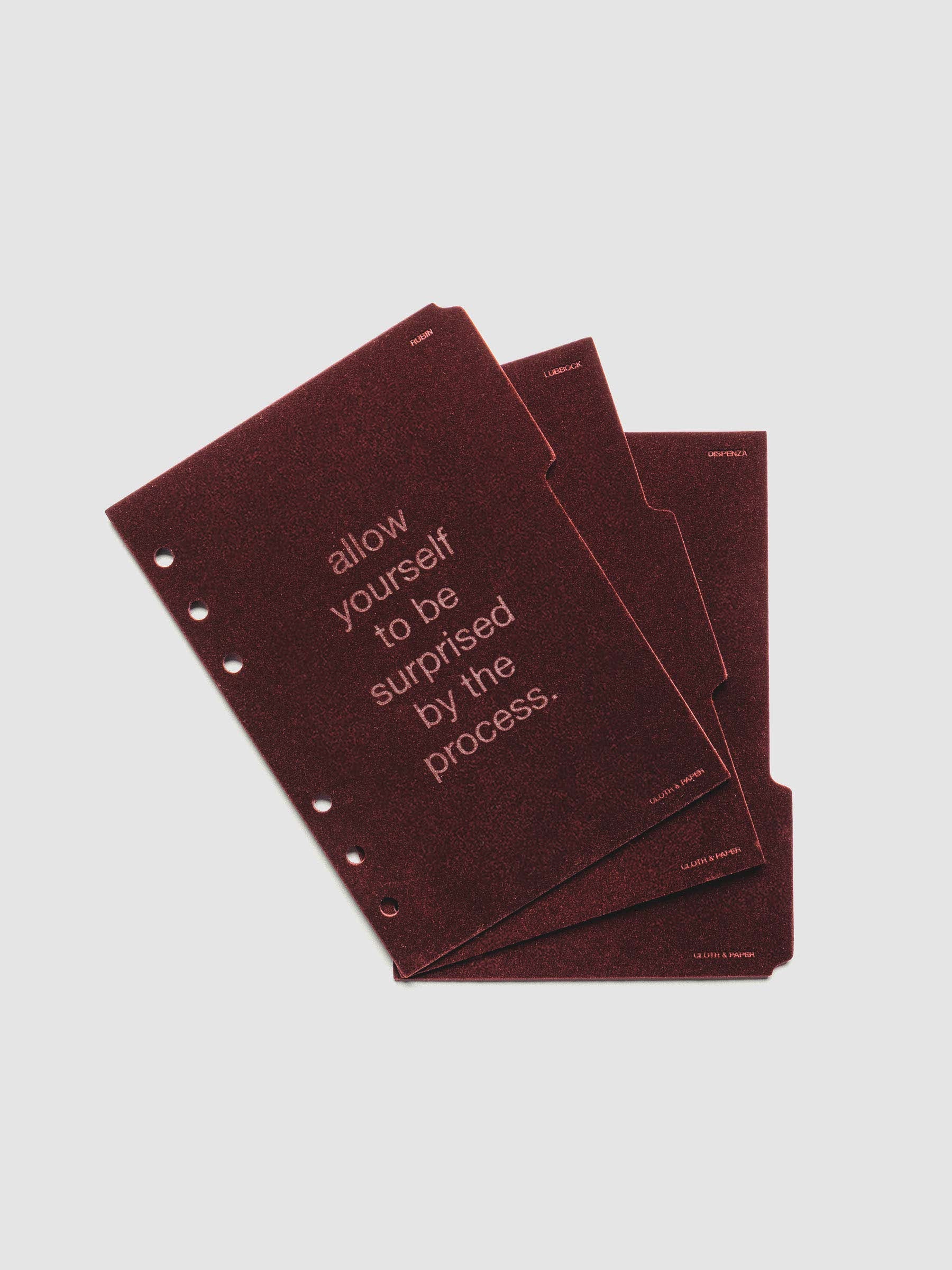 Three velvet side tab planners dividers in the color Bordeaux with text deboss designs shown offset in size A6.