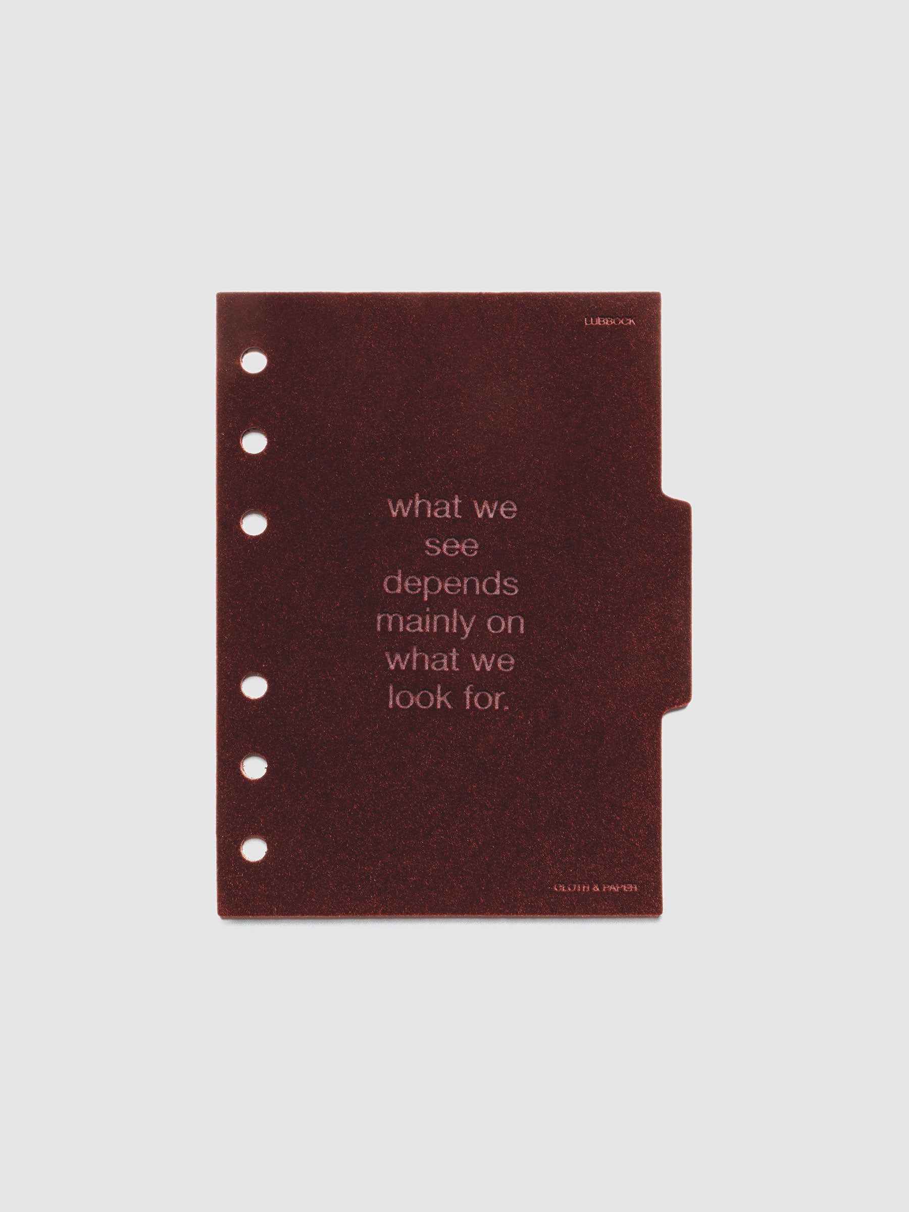 Second velvet side tab planners dividers in the color Bordeaux with text deboss design reading "what we see depends mainly on what we look for" in size A6.