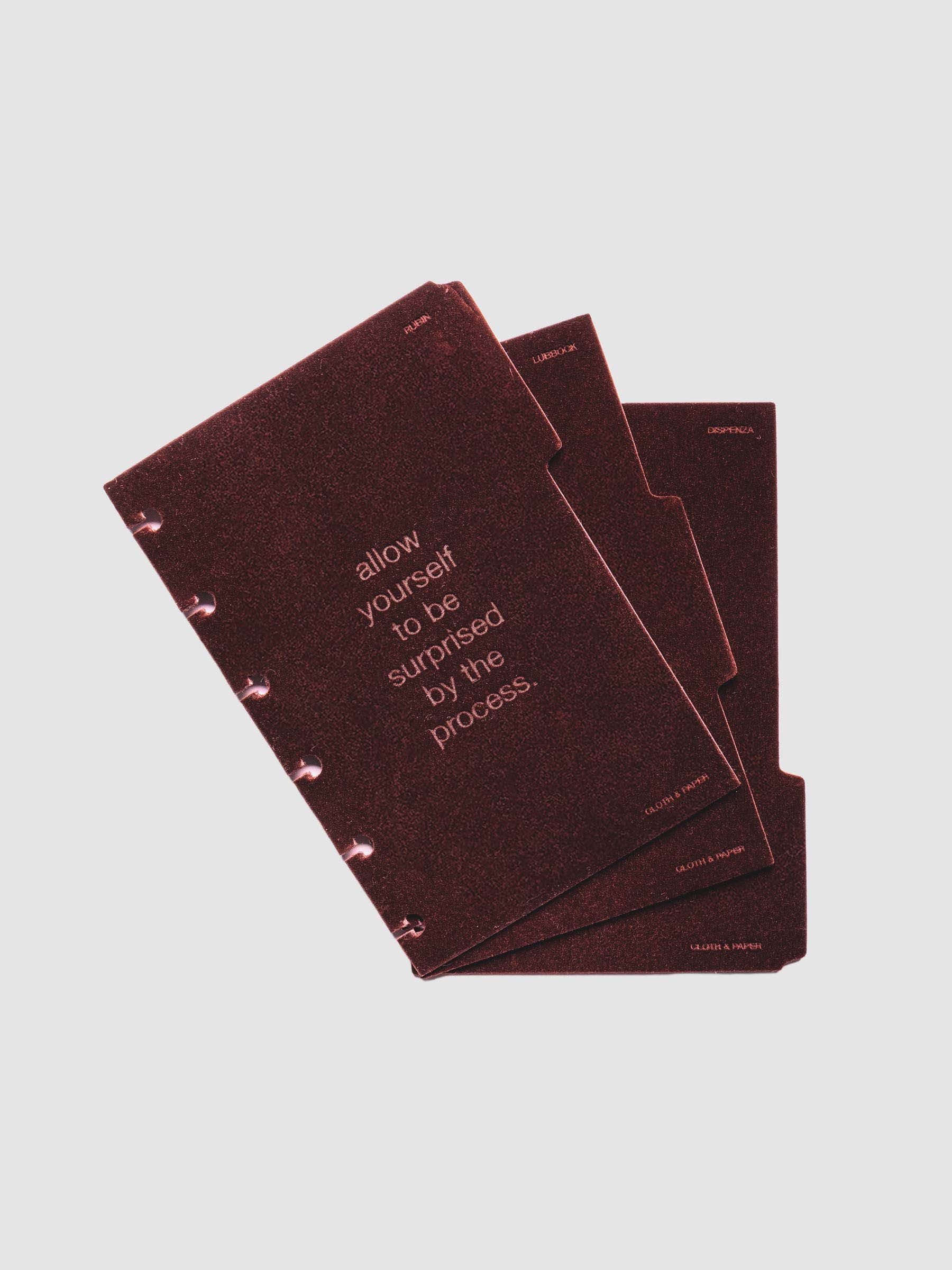 Three velvet side tab planners dividers in the color Bordeaux with text deboss designs shown offset in size CP Petite.
