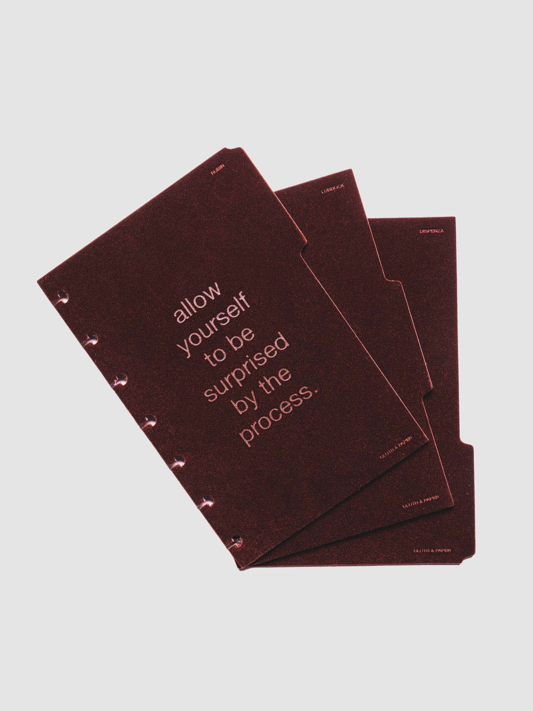 Three velvet side tab planners dividers in the color Bordeaux with text deboss designs shown offset in size HP Mini.