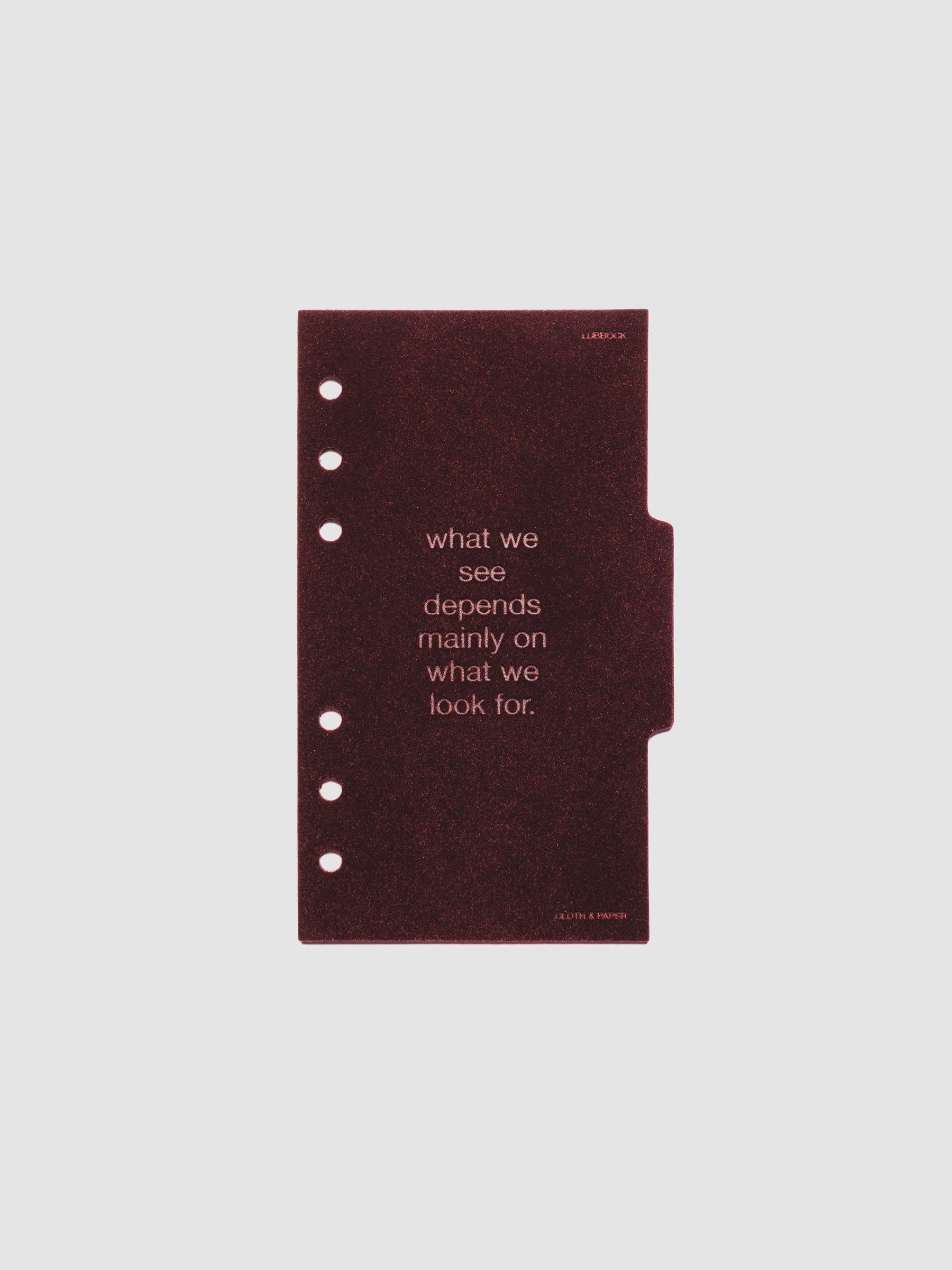 Second velvet side tab planners dividers in the color Bordeaux with text deboss design reading "what we see depends mainly on what we look for" in size Personal.