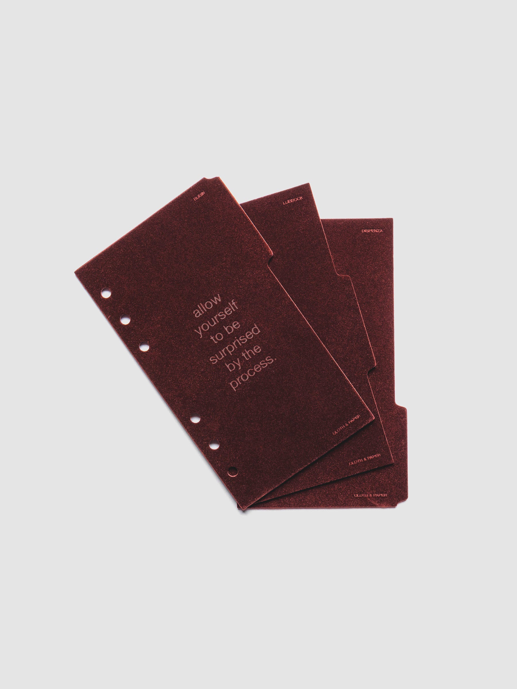Three velvet side tab planners dividers in the color Bordeaux with text deboss designs shown offset in size Personal.