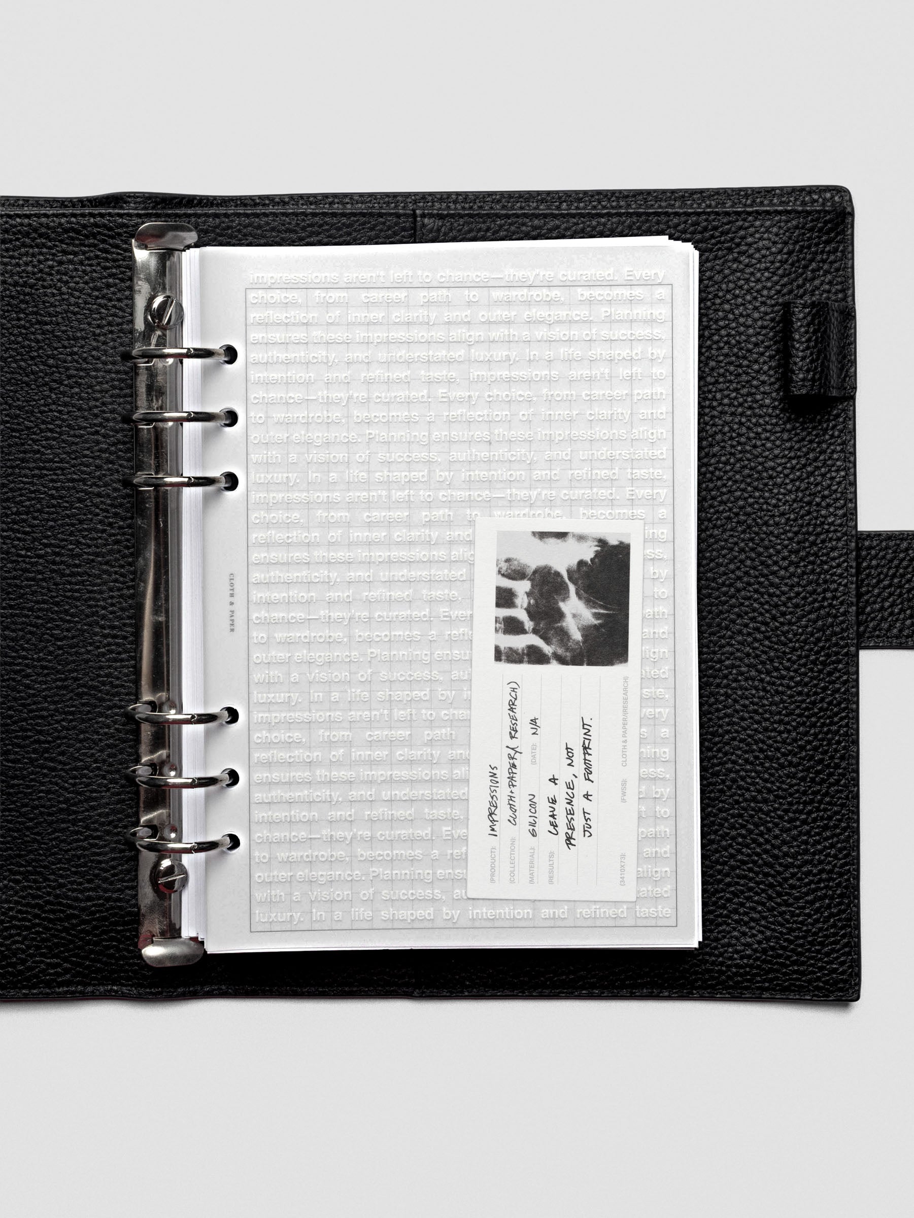 A5 Impressions Dashboard placed in an open planner, layered over minimal inserts.