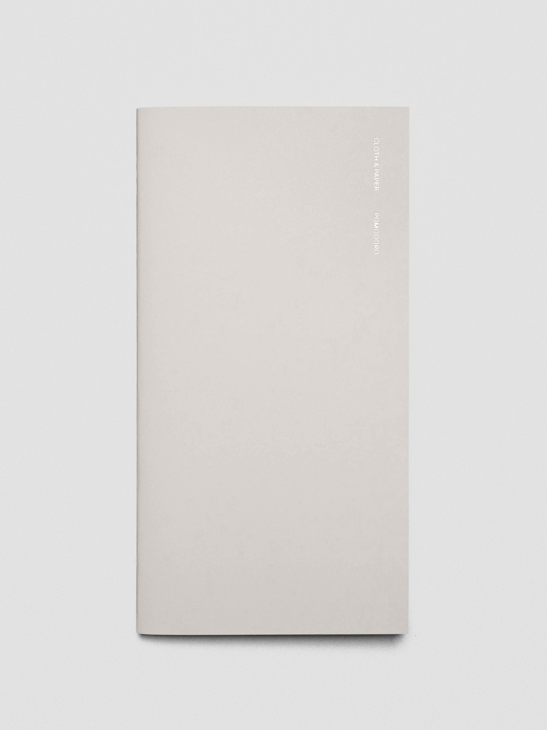 Cover of the Pomodoro A5 Slim notebook placed flat on a desk.