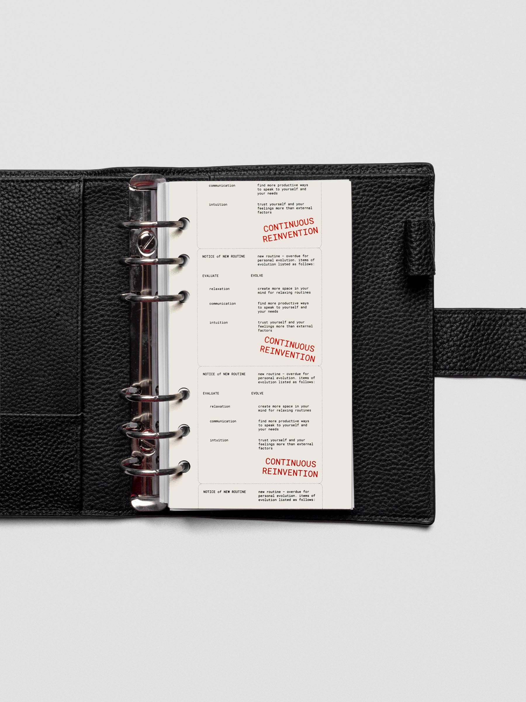 Personal-size Reinvention Dashboard inside a ring-bound planner with translucent layering.