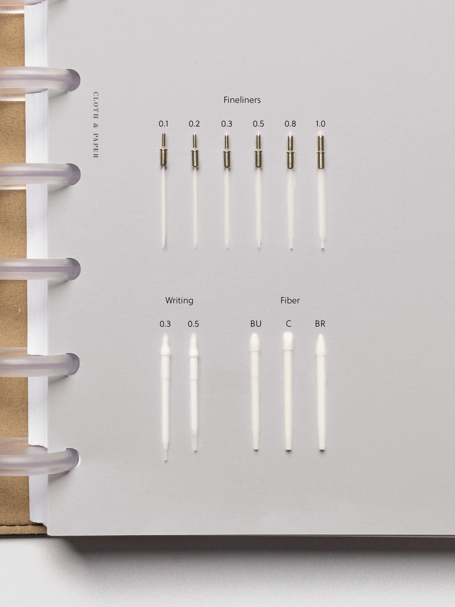 Assortment of Lumos Pro pen tips including fineliners, brush tips, and writing nibs.