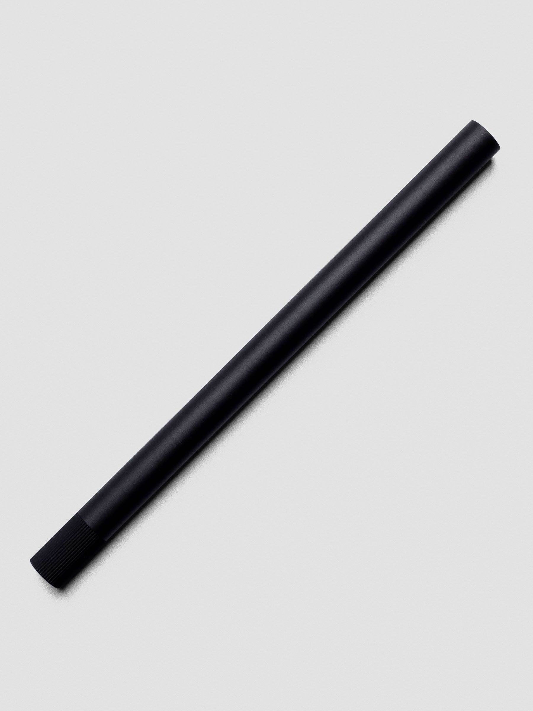 Lumos Pro Single Tip Pen in Matte Black, shown capped on neutral background.