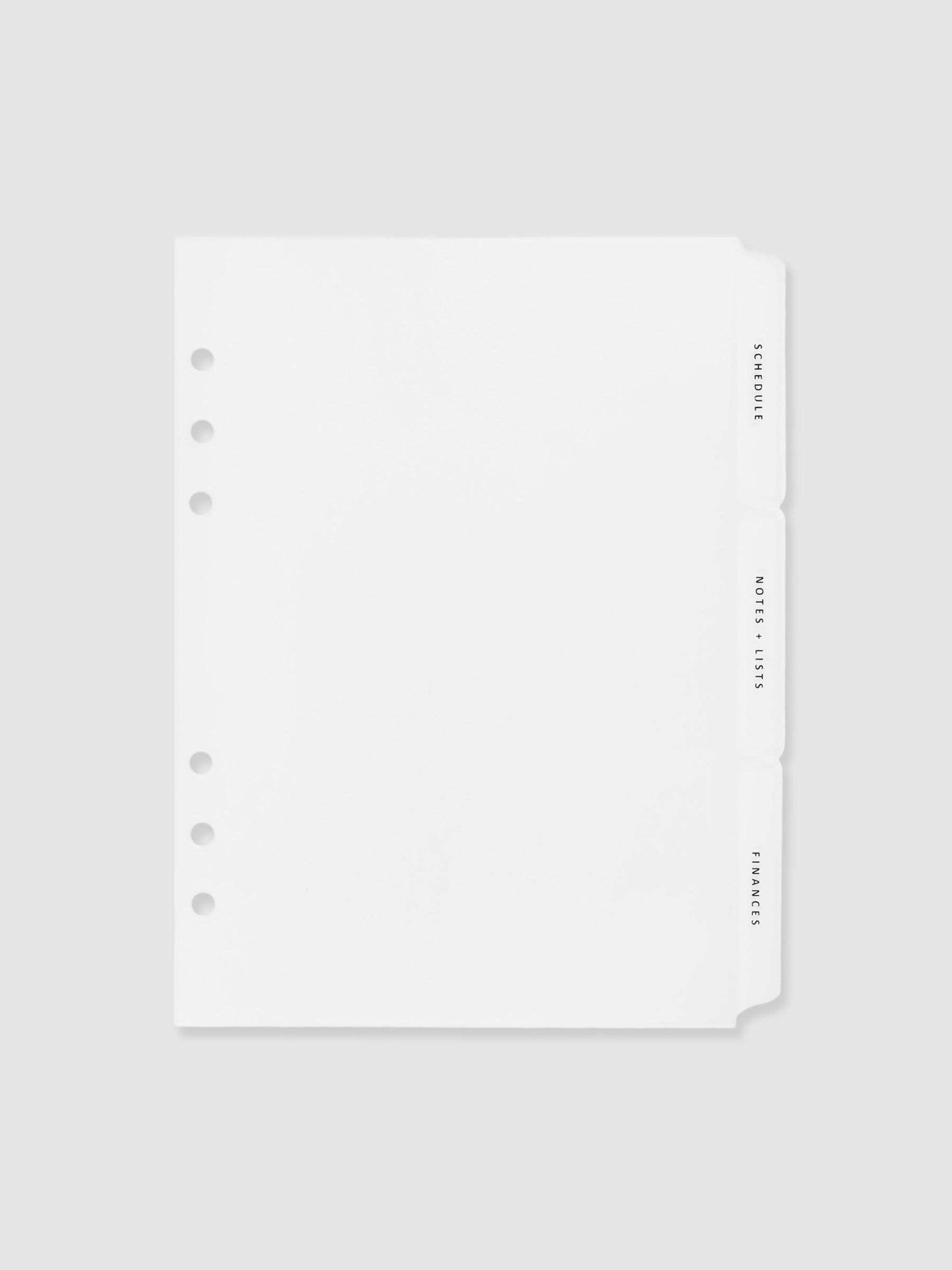 The Essentials Side Tab Planner Dividers, Glass Plastic, Black Text, Cloth and Paper. Dividers turned slightly to the left against a neutral background.