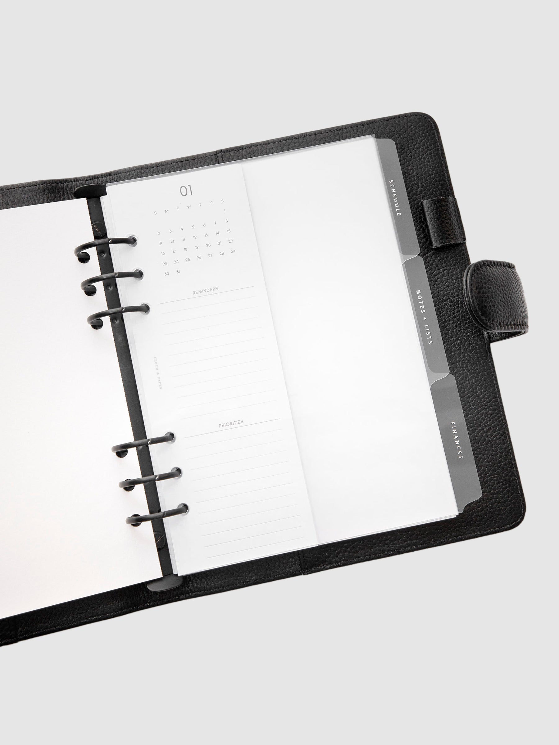 White Essentials Side Tab Planner Dividers Glass Plastic in use inside a black leather folio.