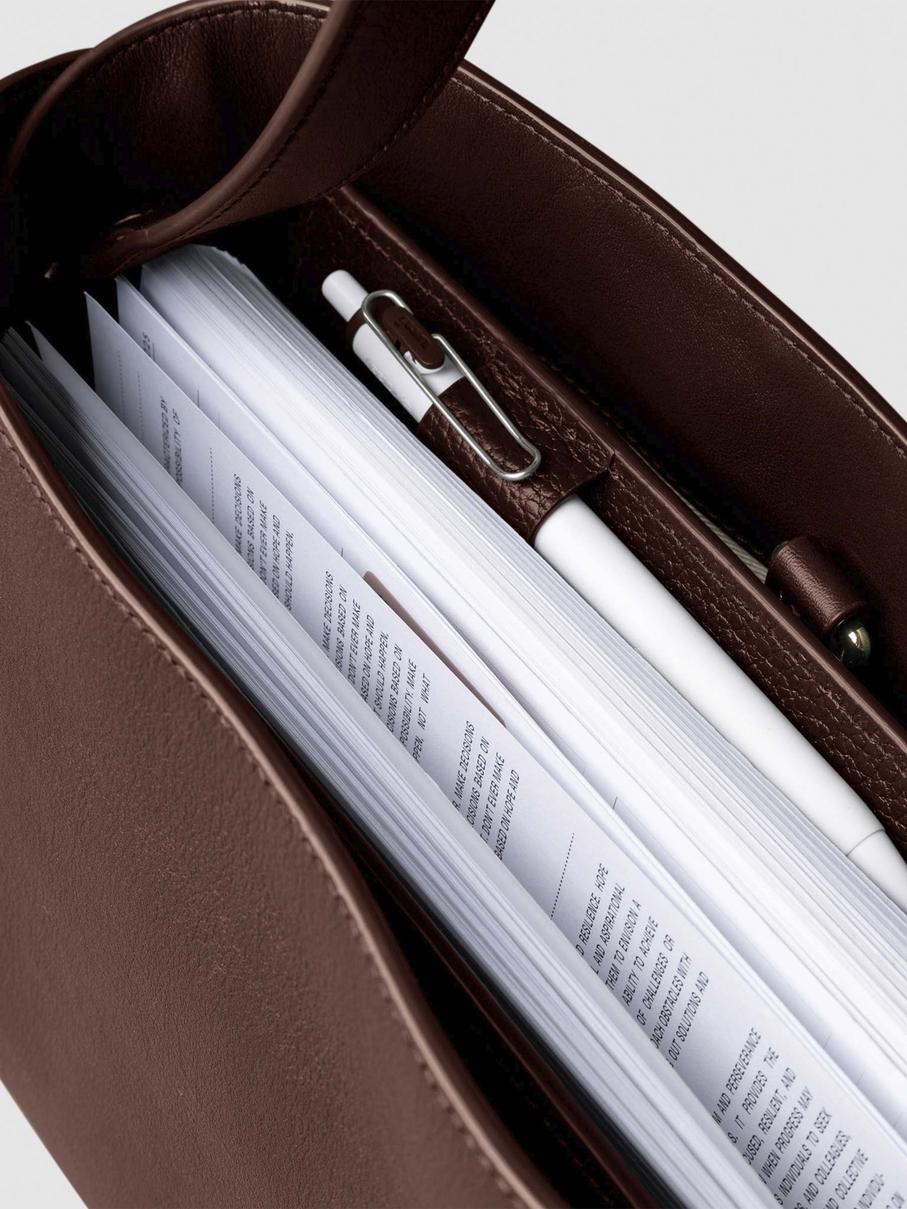 Bag shown from above with a planner inside of it. Color shown is Cordoba.