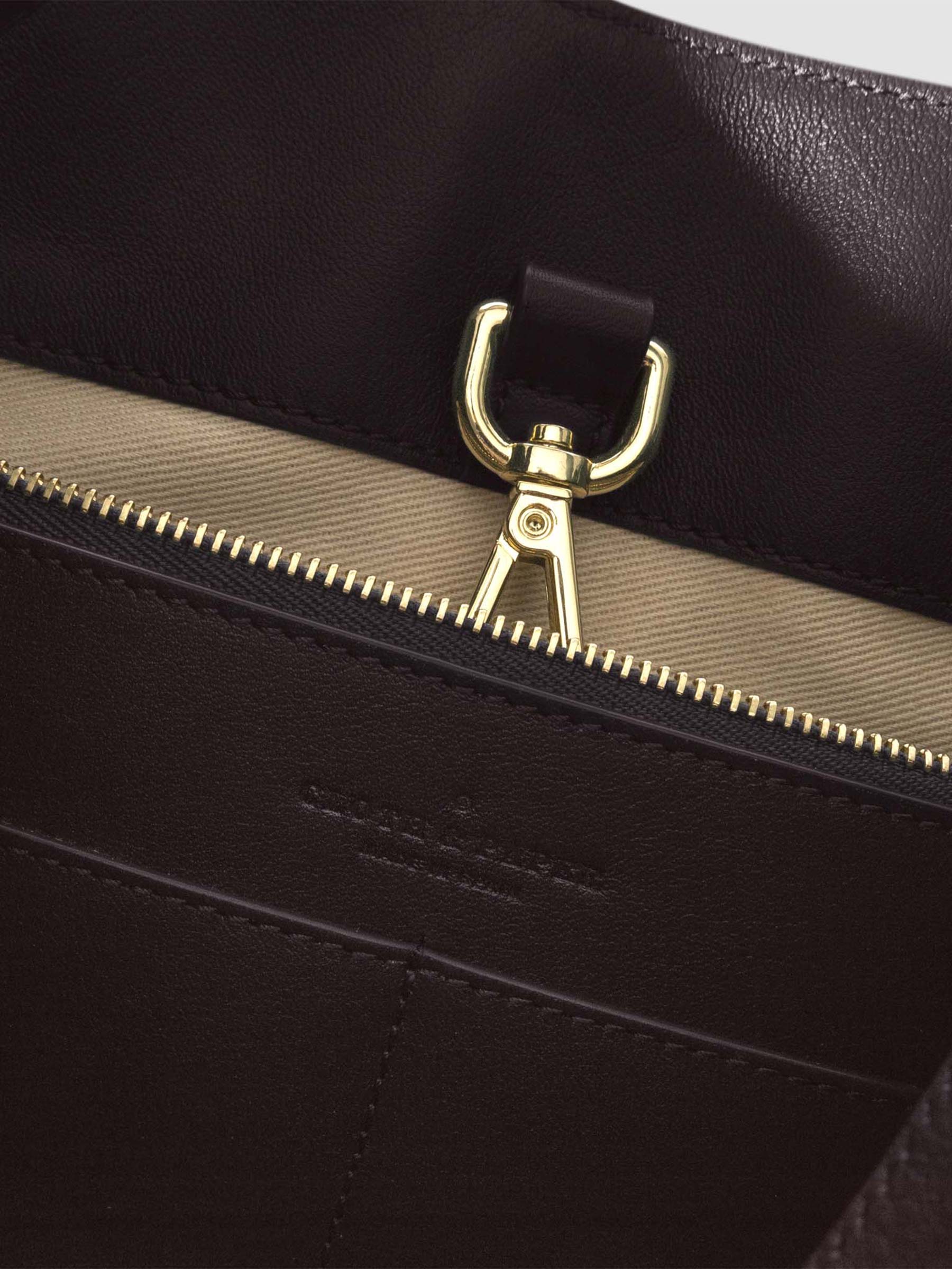 Top down view of bag showcasing its gold hardware. It secures the bag shut. Color shown is Madrid.