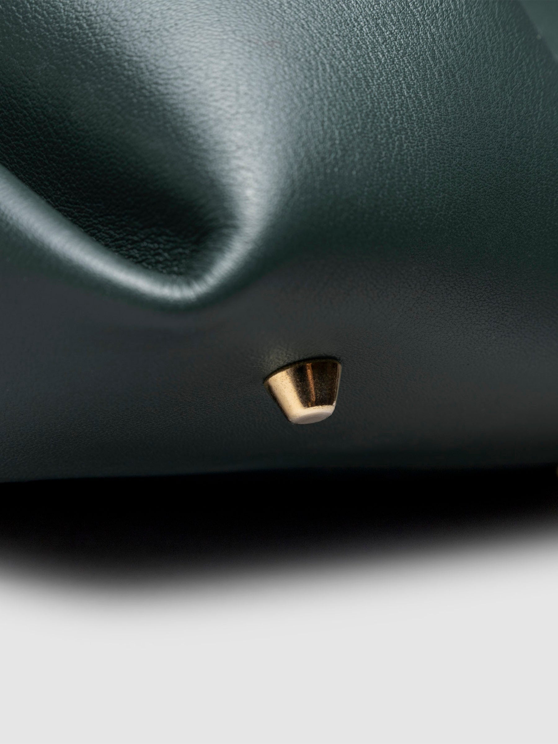 Closeup of the gold feet on the bottom of the bag. Color shown is Salamanca.