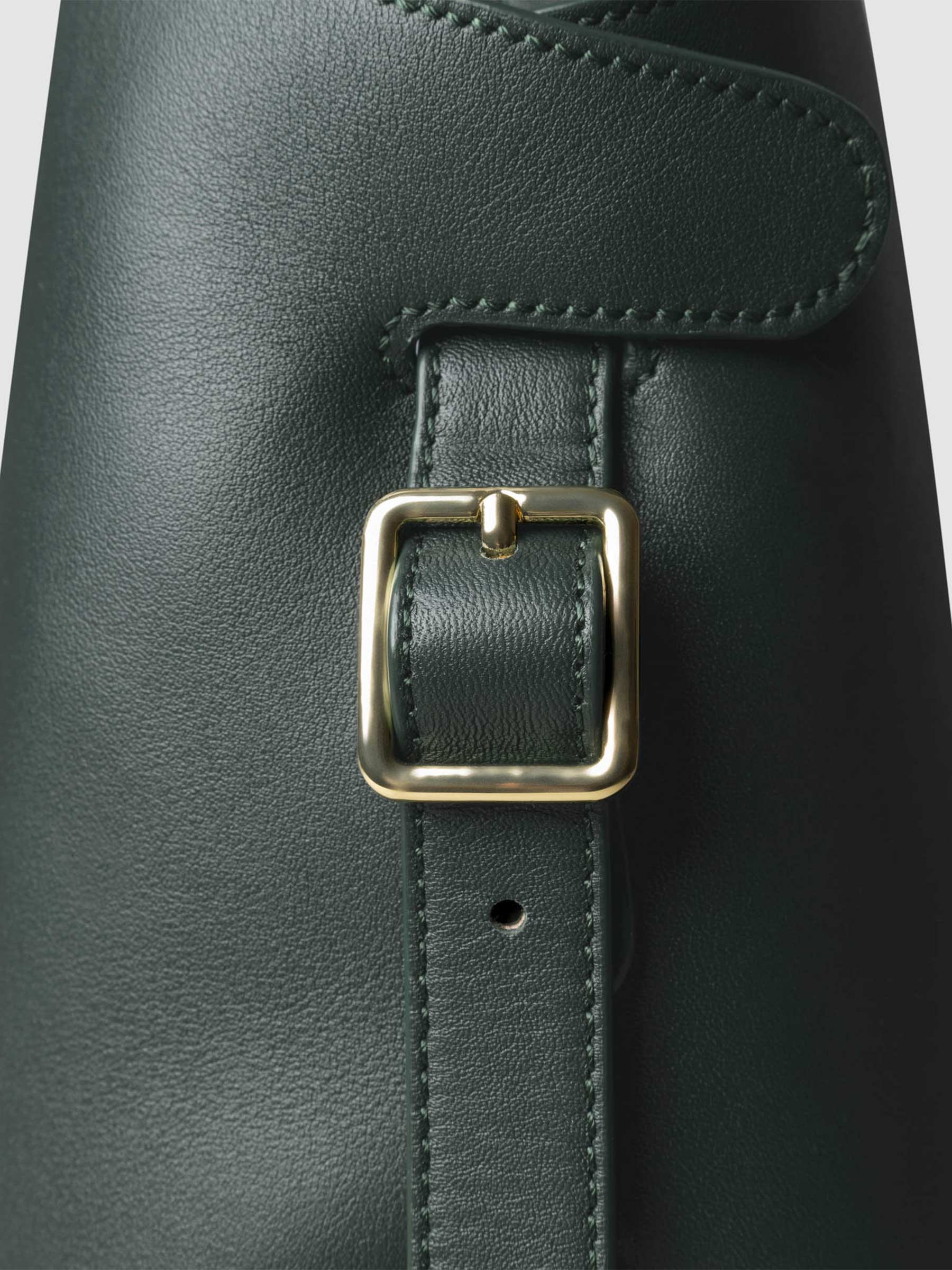 Side view of bag showcasing its gold hardware and adjustable leather strap. Color shown is Salamanca.