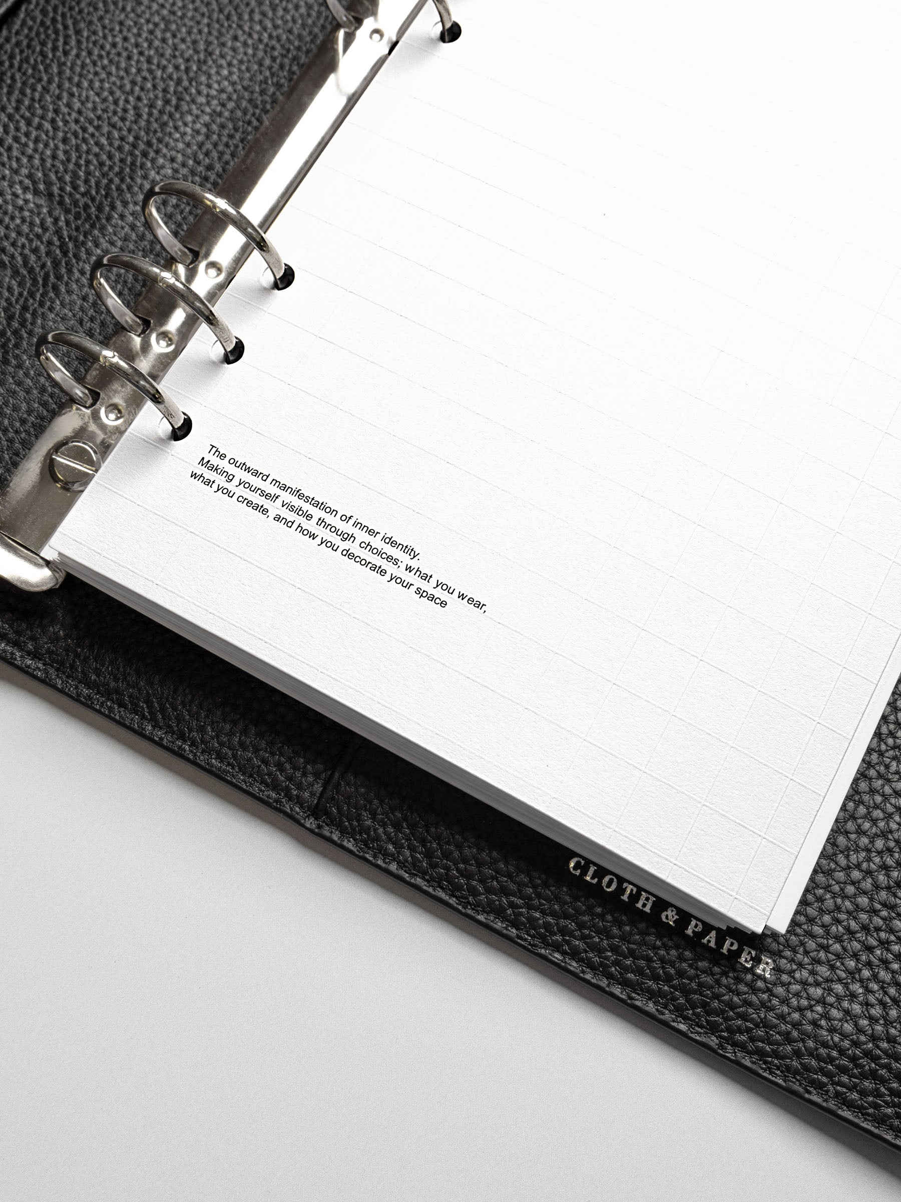 Detailed view of the lower corner of the A5 Tile Planner Dashboard showing a quote about inner identity printed on the page.