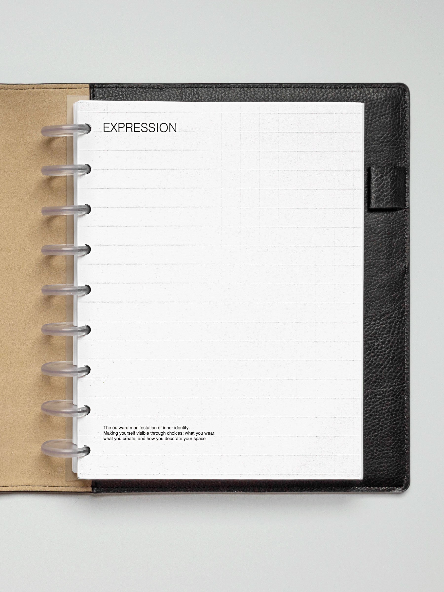 HP Classic Tile Planner Dashboard inserted into a tan and black disc-bound planner, showing the full grid design and "EXPRESSION" heading.