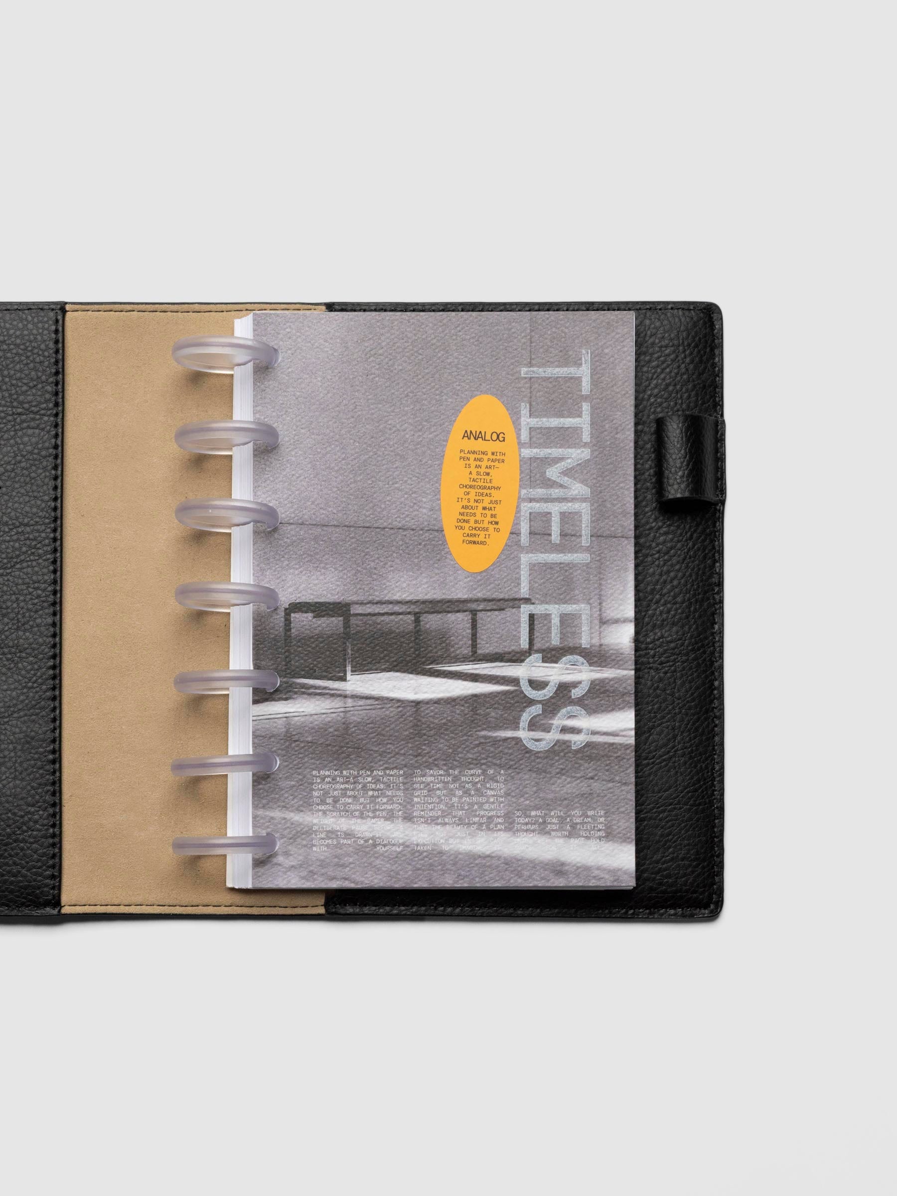 HP Mini dashboard displayed in a leather planner on a neutral background.