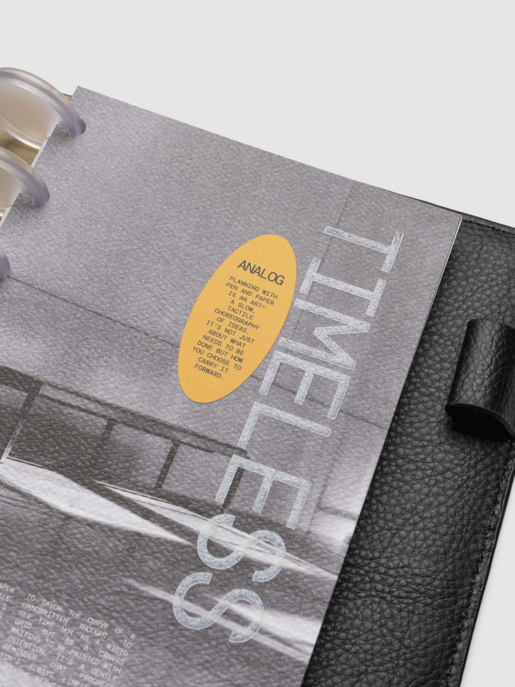 Closeup of HP Mini dashboard inside a leather planner displayed on a neutral background.