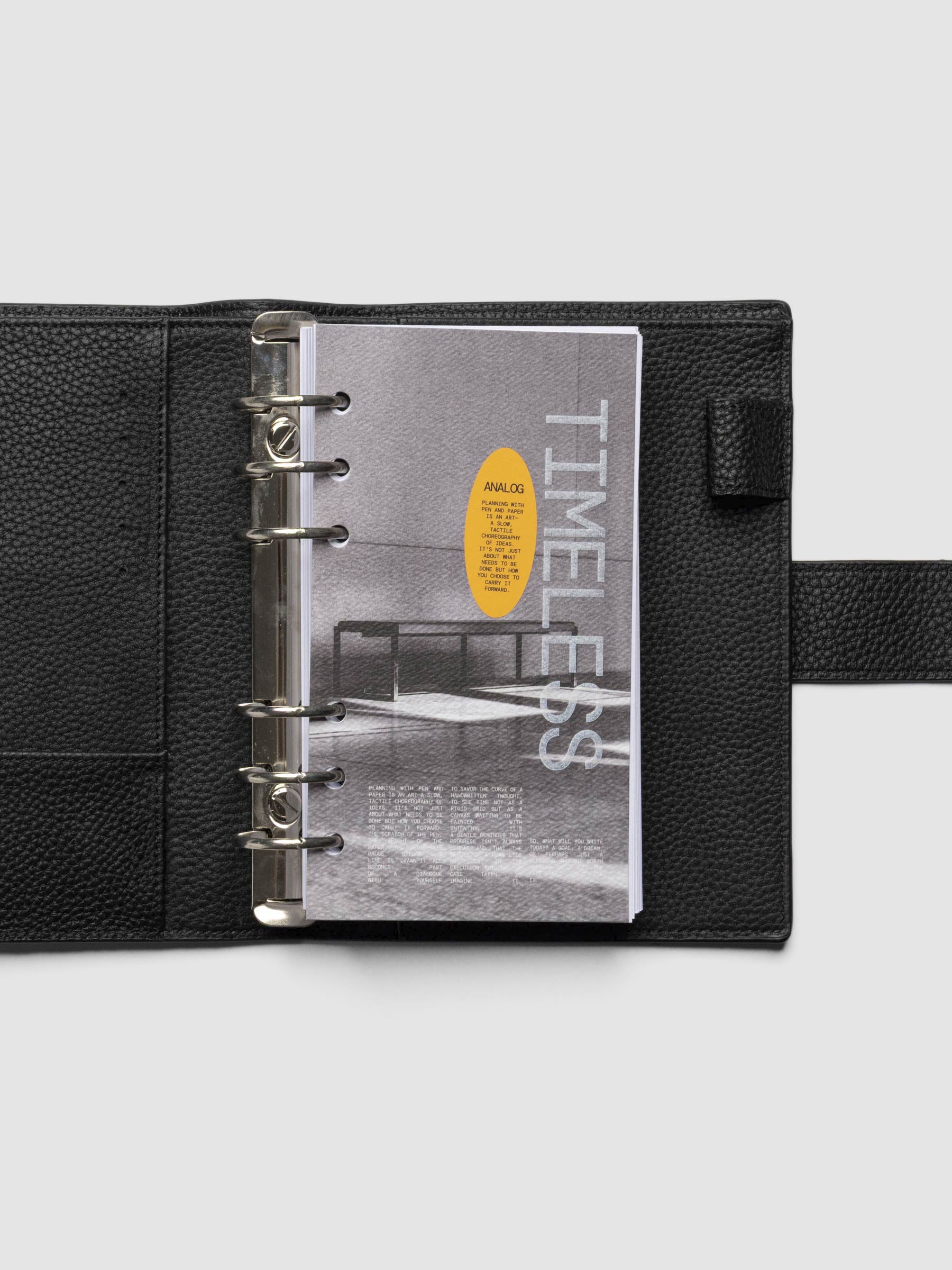 Personal dashboard displayed in a leather planner on a neutral background.