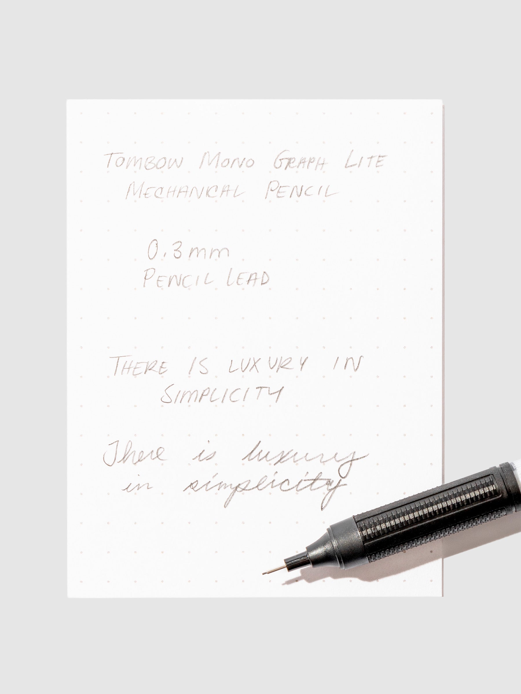 Writing sample with pencil displayed on a  background.eutral
