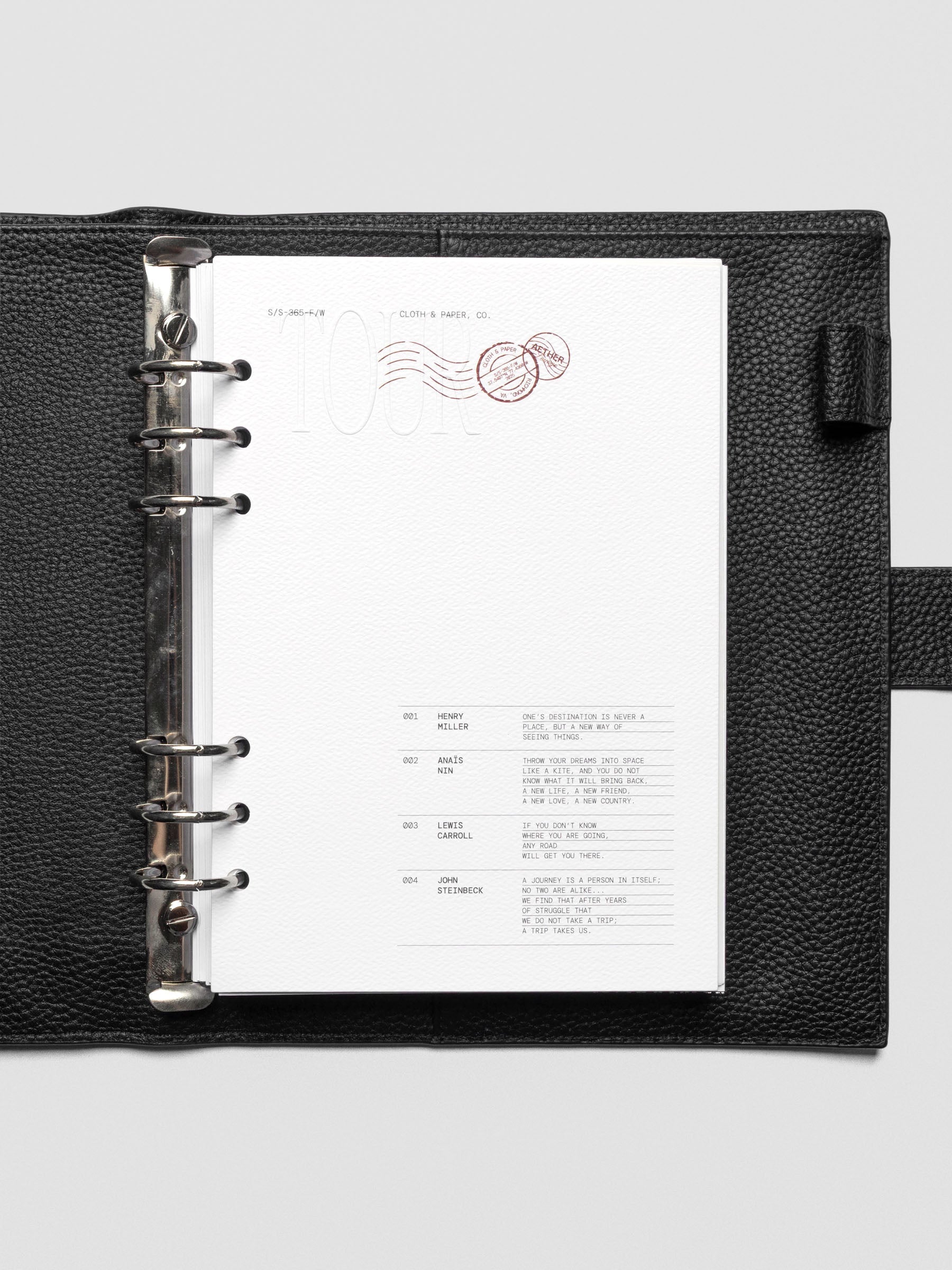 Tour Dashboard A5 inserted in planner, showing contrast of white page with red detail.