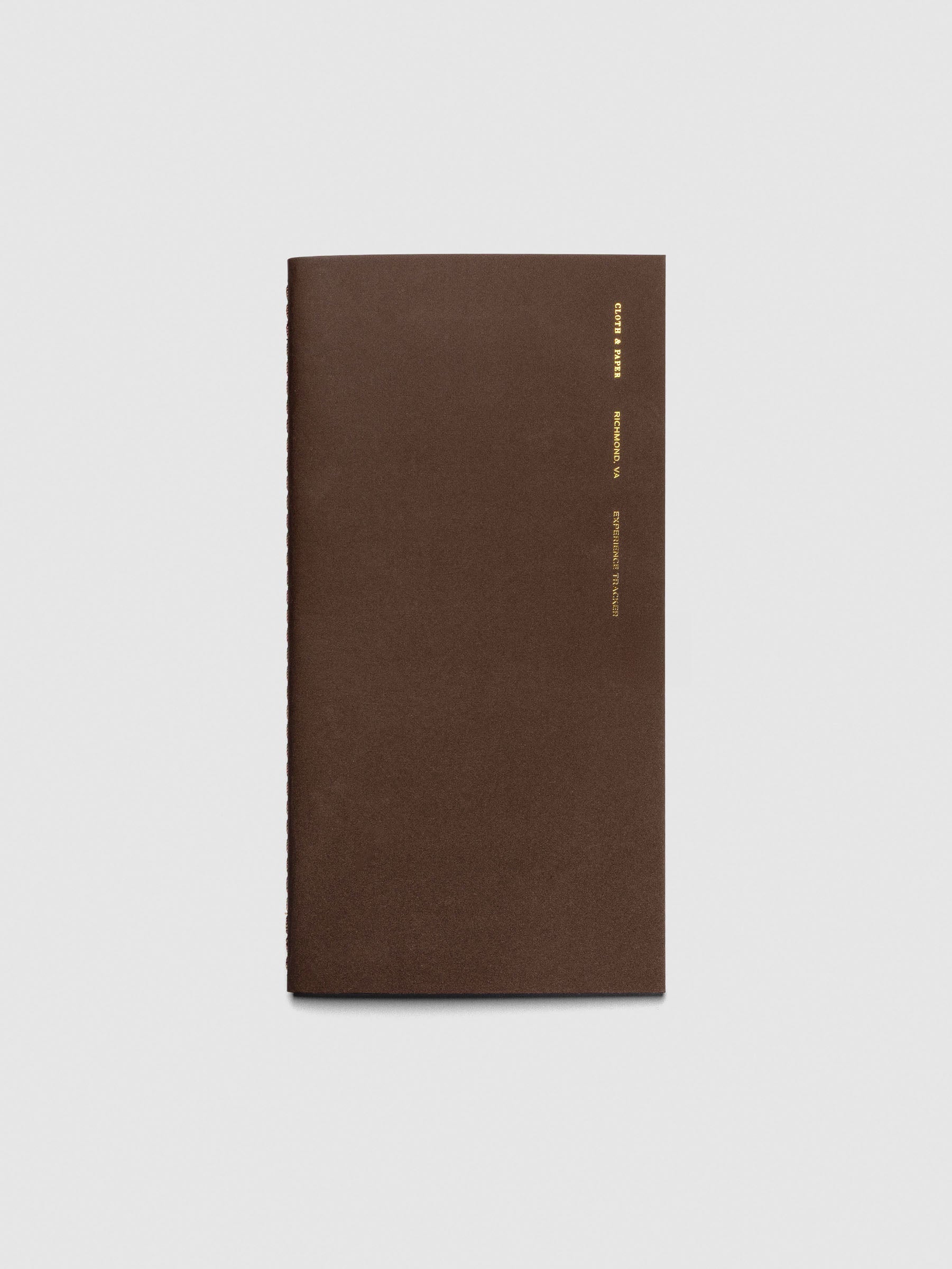 Travel Notebook | A5 Slim - Experience Tracker in Walnut color, featuring a minimalist brown cover with gold foil-stamped text along the edge.