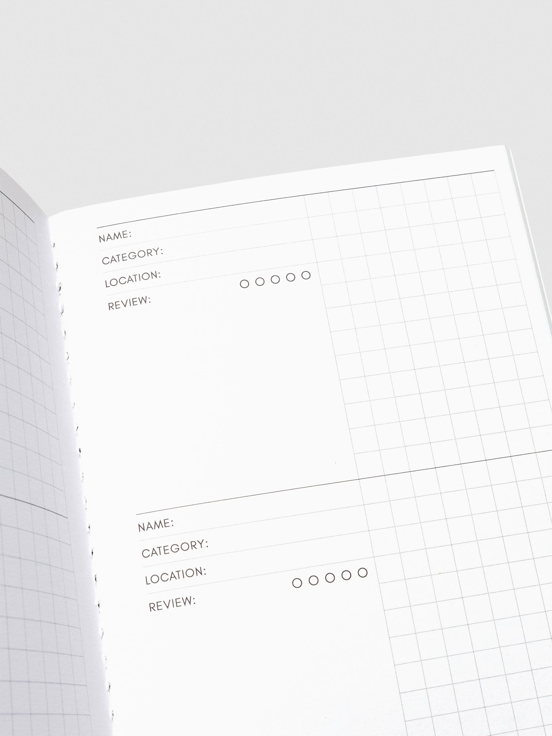 Detailed interior spread of the Experience Tracker notebook, displaying multiple entry sections with prompts for Name, Category, Location, Review, and a gridded notes column.
