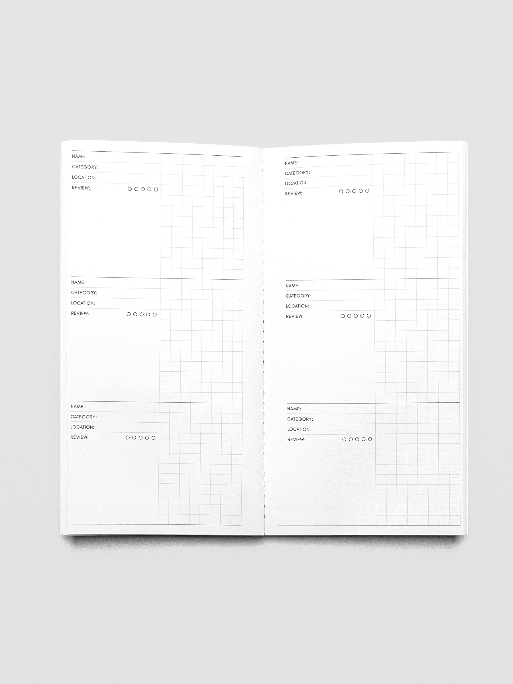 A5 Slim Travel Notebook shown open displaying the Experience Tracker page layouts.