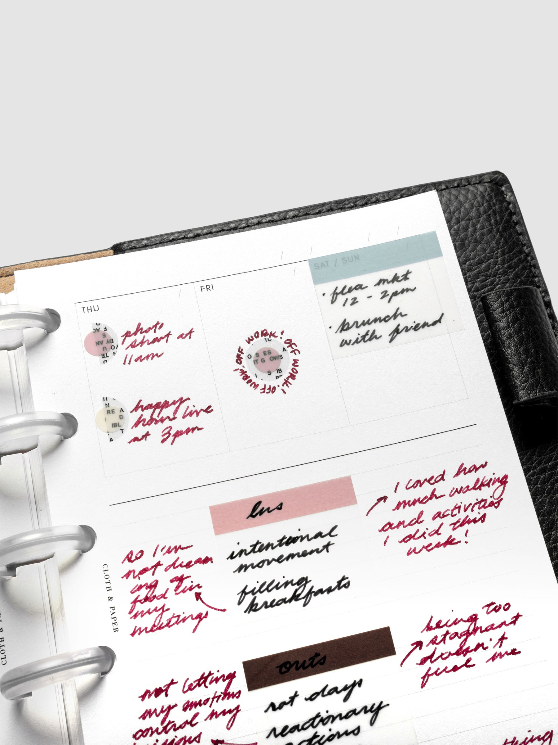 Close up view of the Undated Weekly Notes Planner Inserts with handwritten notes, page flags, and stickers.