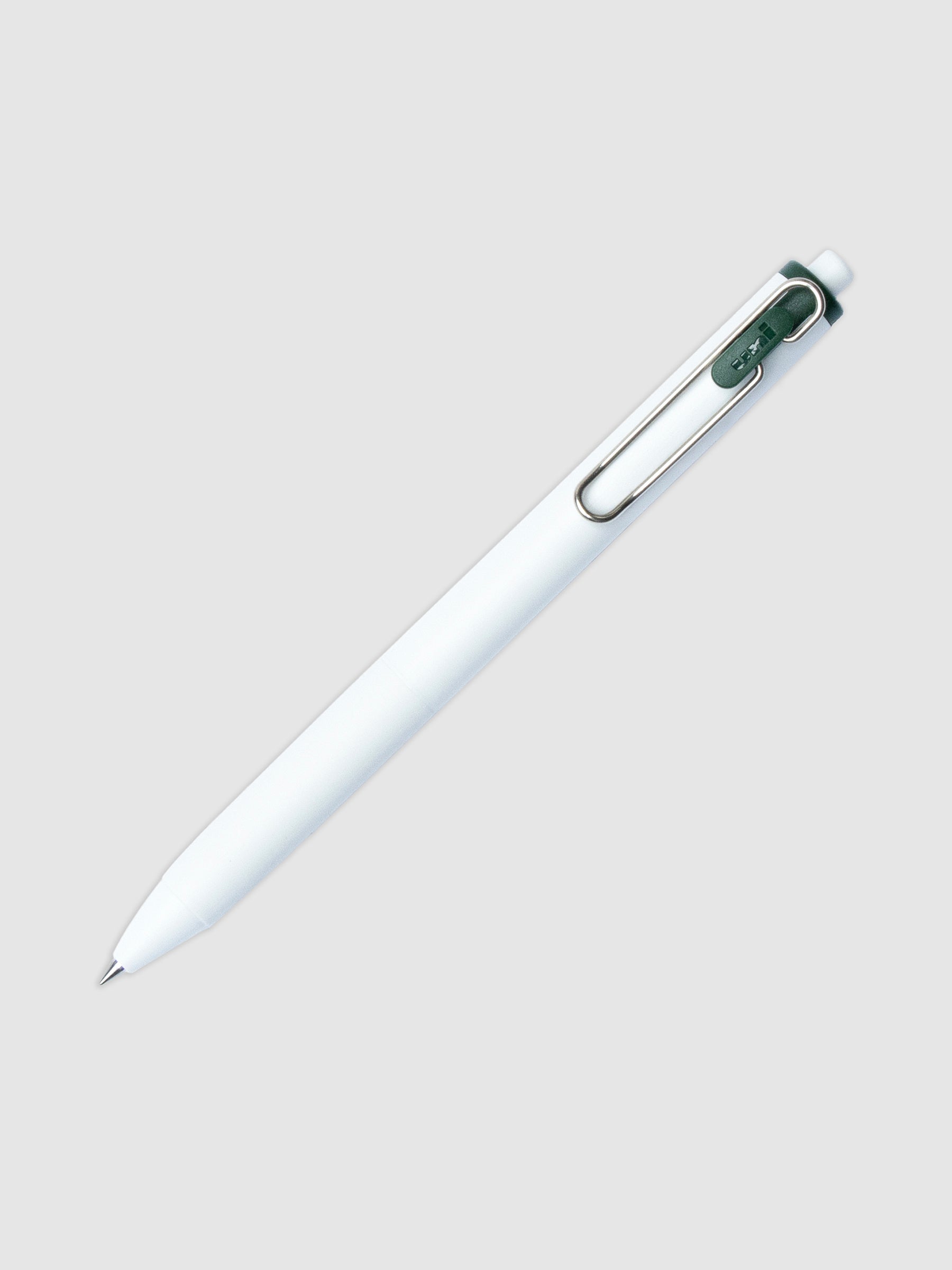 Uni-ball One Gel Pen, Green Black, Cloth and Paper. Pen tilted slightly to the right on a neutral background.