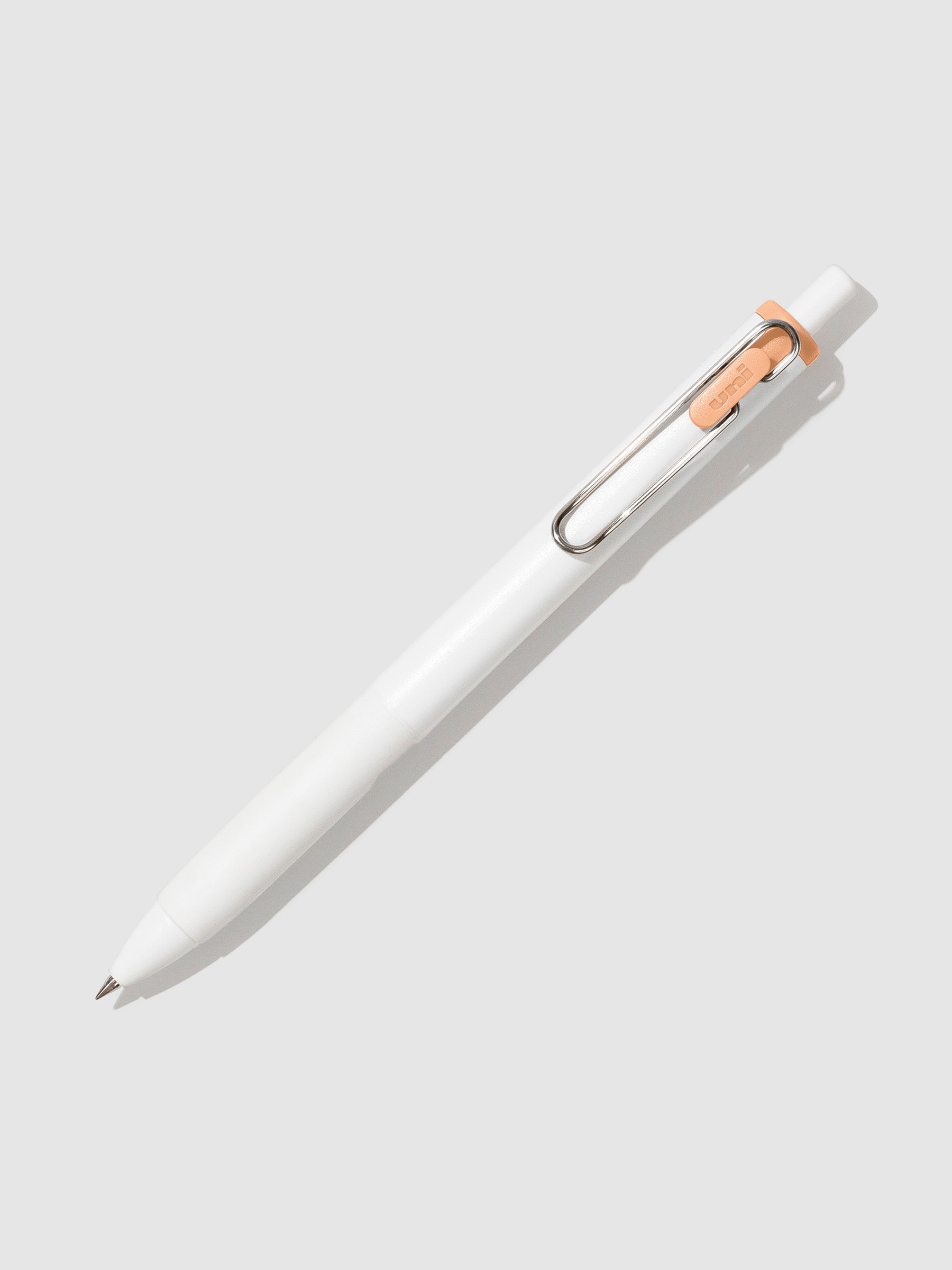 Pen tilted slightly to the right on a neutral background. Color pictured is Mango Orange.