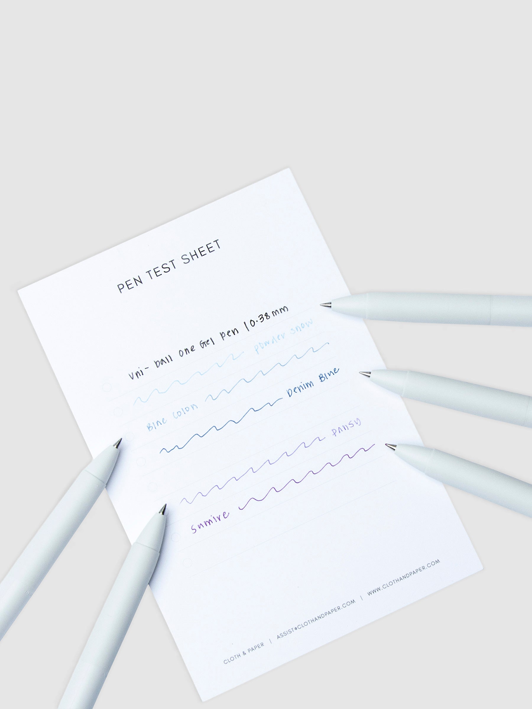 Pen test sheet showing ink samples for Peach Canele, Apple Gum, Anemone, Bordeaux Black, and Green Black ink. Five pens are resting on the edges of the pen test sheet.