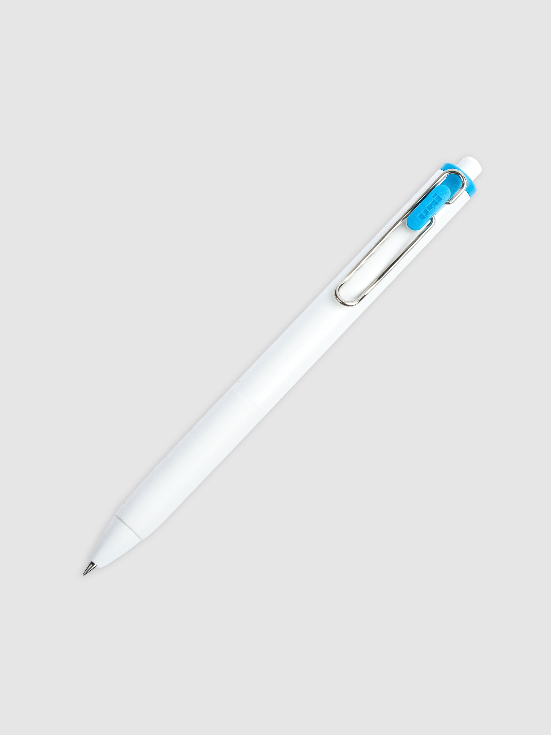Uni-ball One Gel Pen, Sunny Day Blue, Cloth and Paper. Pen tilted slightly to the right on a neutral background.