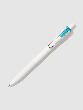 Uni-ball One Gel Pen, Sky Blue, Cloth and Paper. Pen tilted slightly to the right on a neutral background.