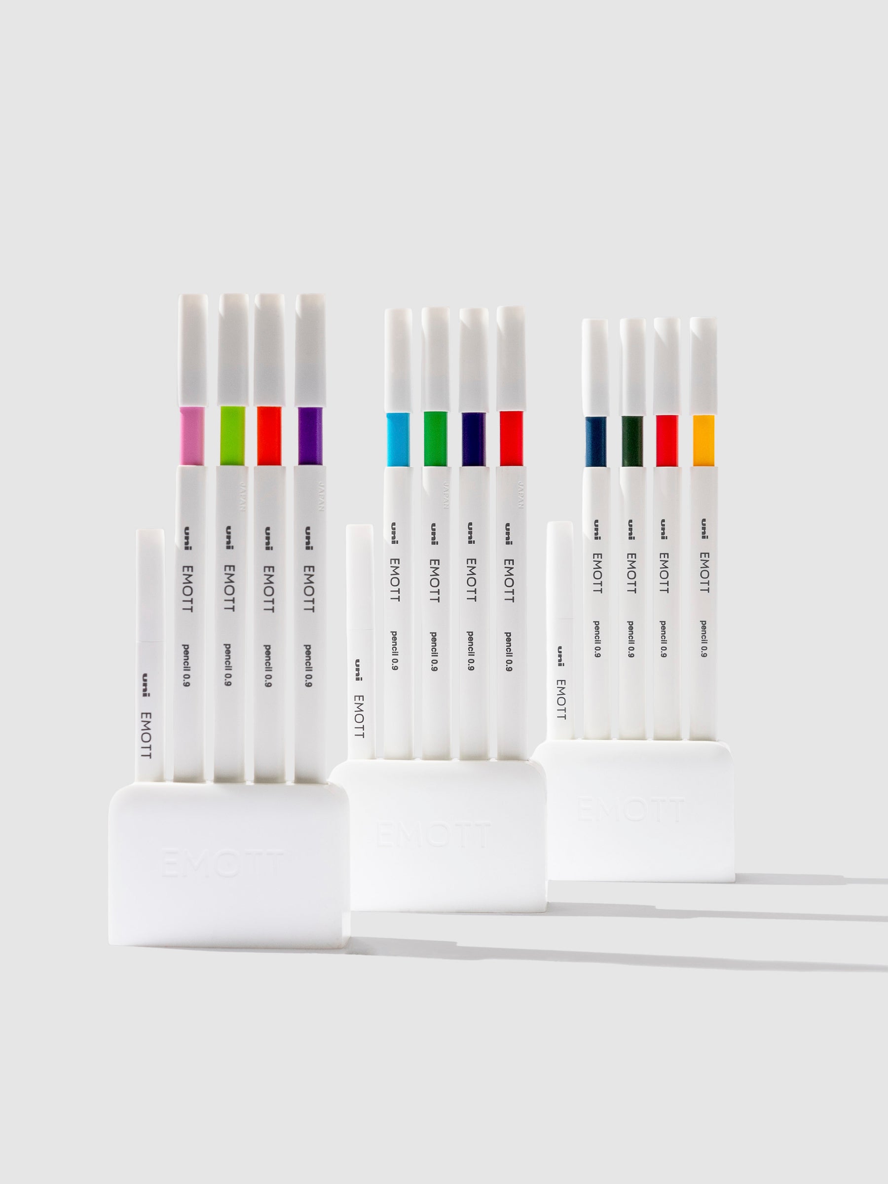 Uni Emott Colored Pencil Set, Cloth and Paper. Three sets of pens displayed on a neutral background.