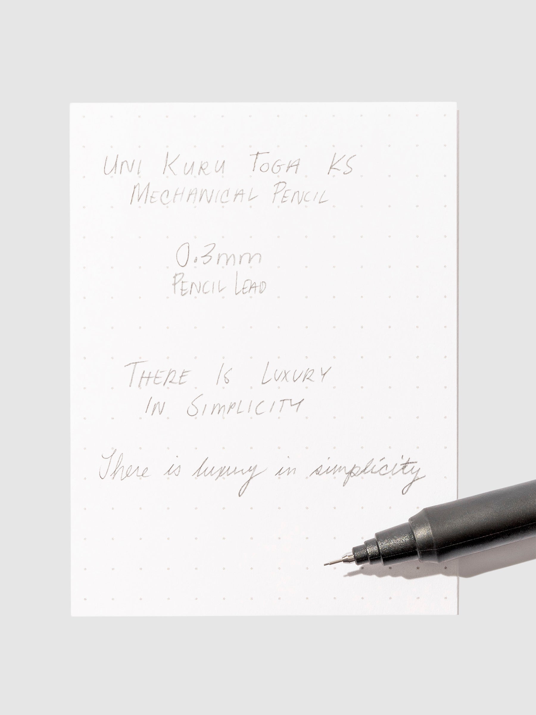 Pen testing sheet in use on a neutral background.