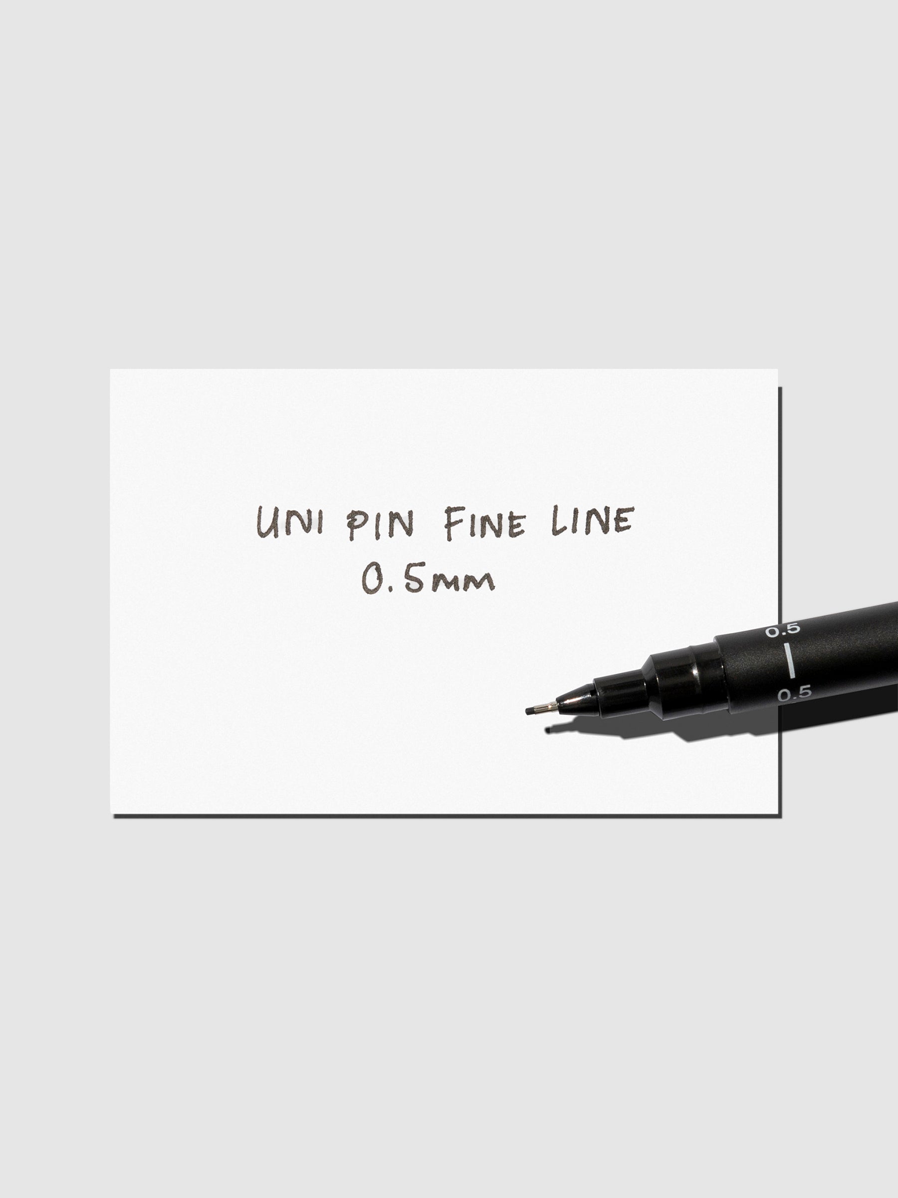 Pen shown resting on an in use tester sheet.