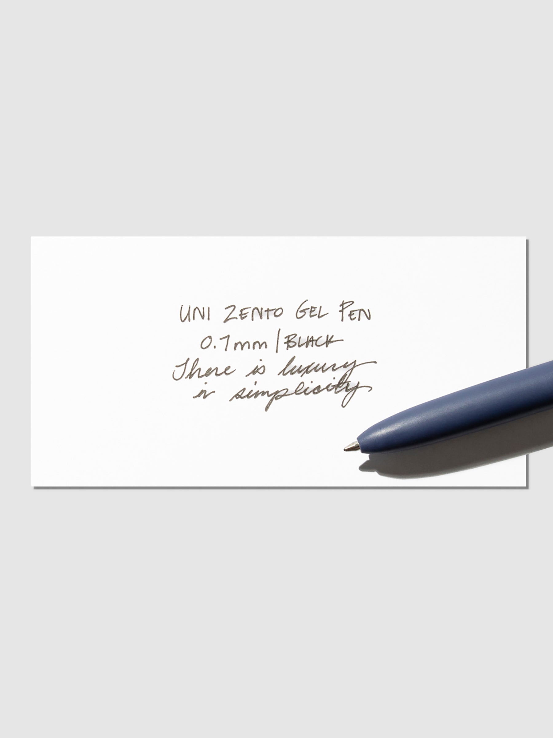 Writing sample shown with pen resting on the testing sheet. Color shown is Coastal.