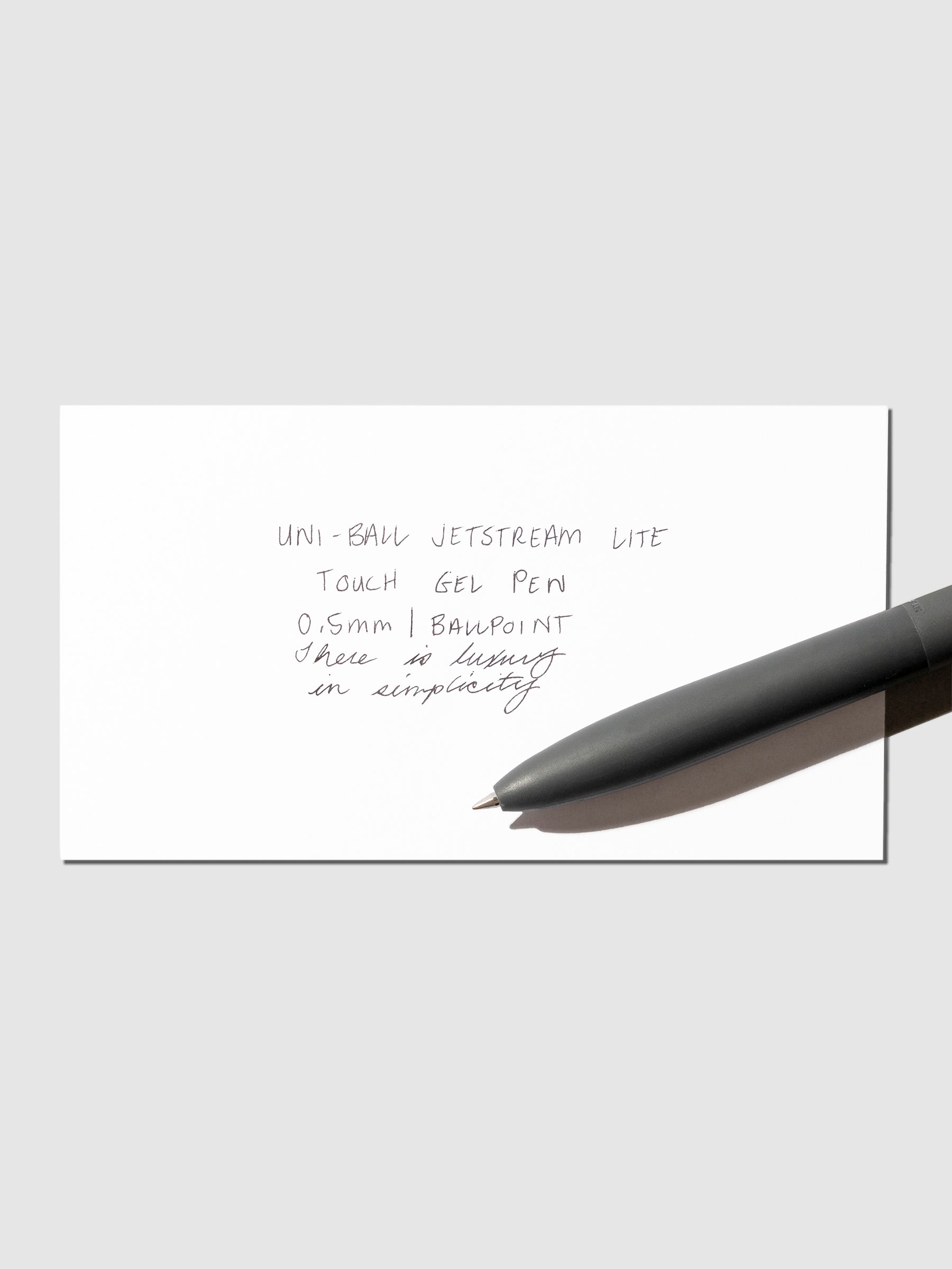Image shows a pen test sheet of the Uni-ball Jetstream LiteTouch Gel Pen in Off Black.