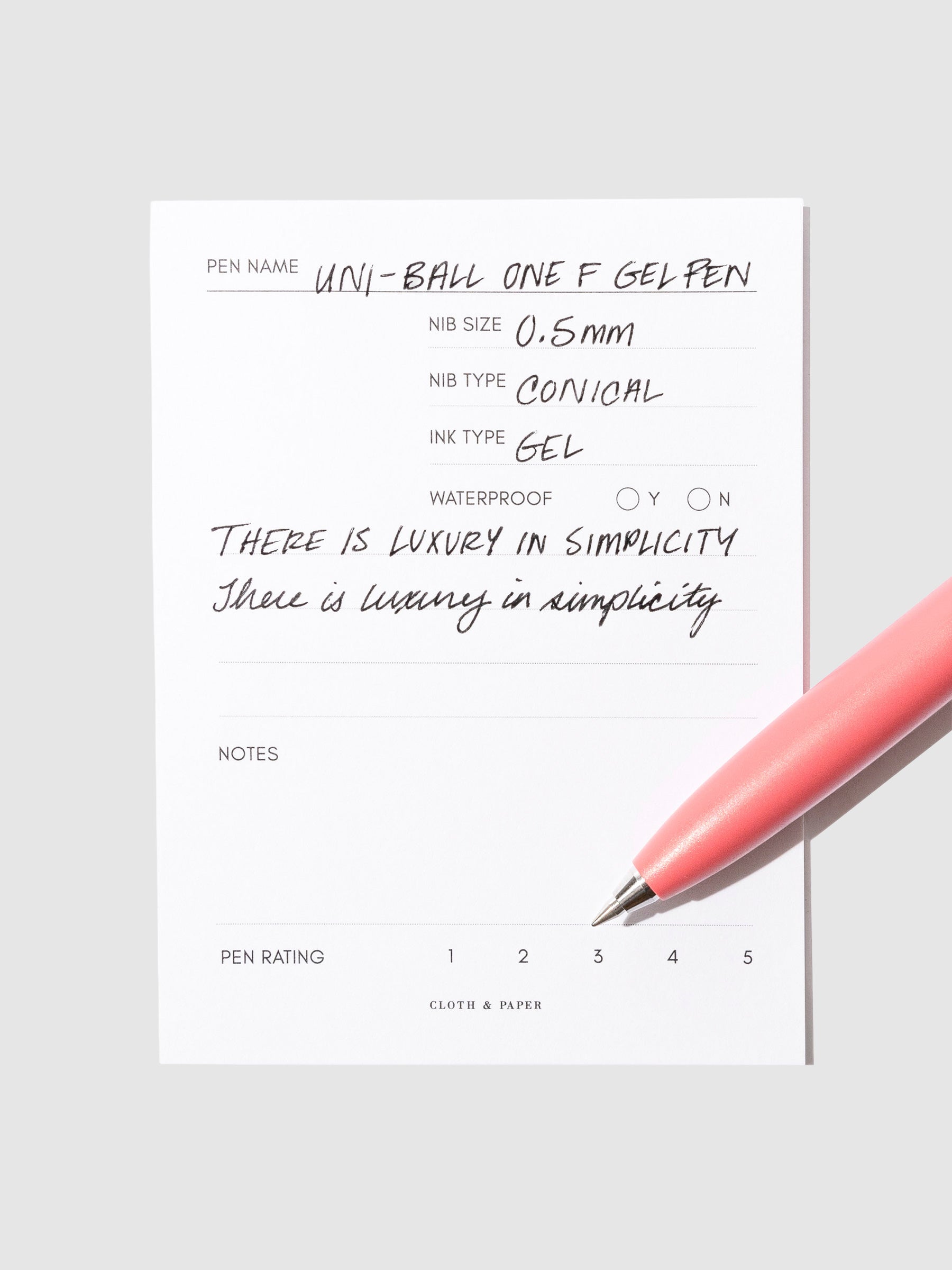 Red pen resting on an in use pen test sheet.