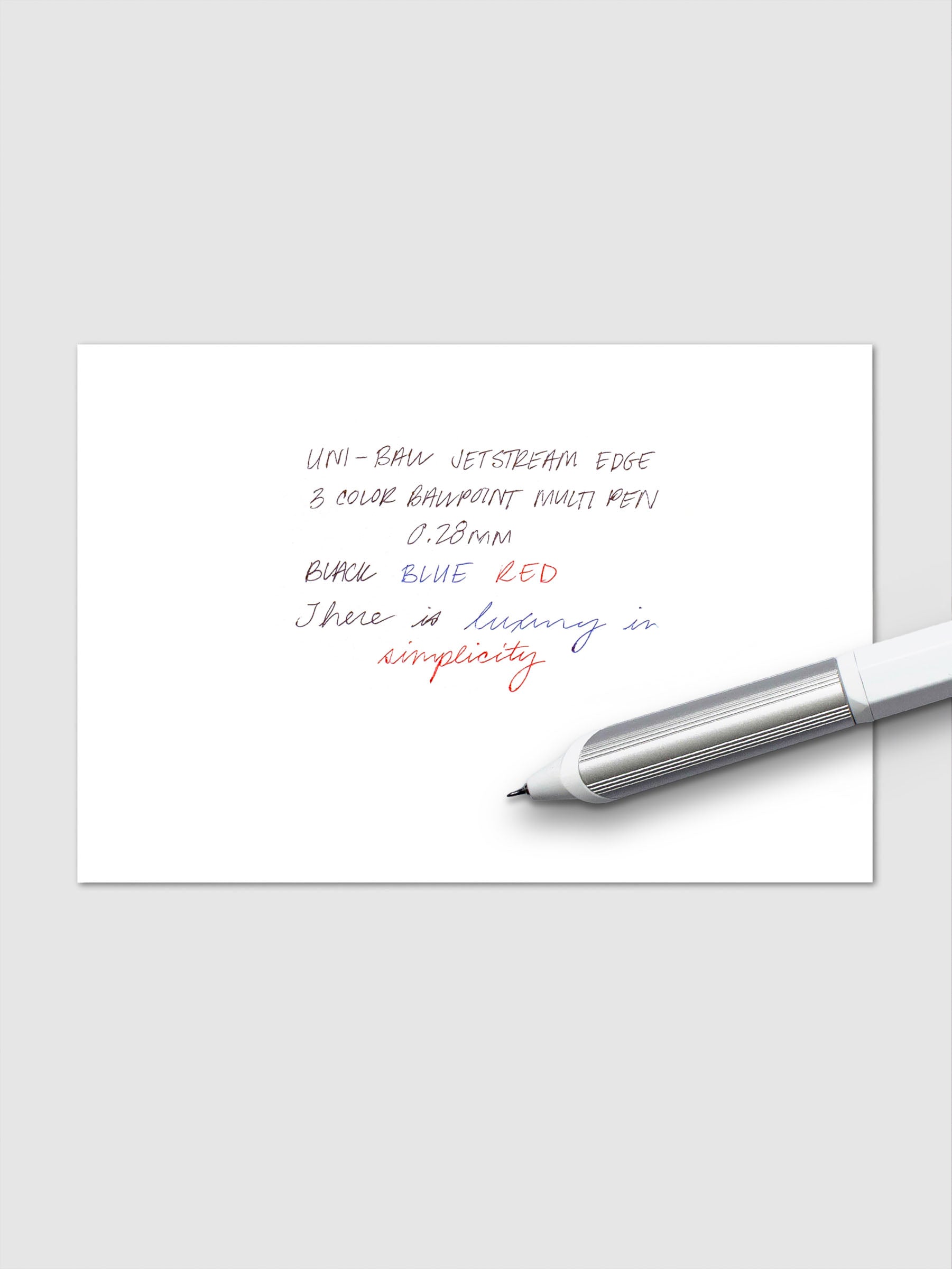 Handwritten writing sample showing blue, red, and black ink using the Uni-ball Jetstream Edge 3 Color Ballpoint Multi-pen.
