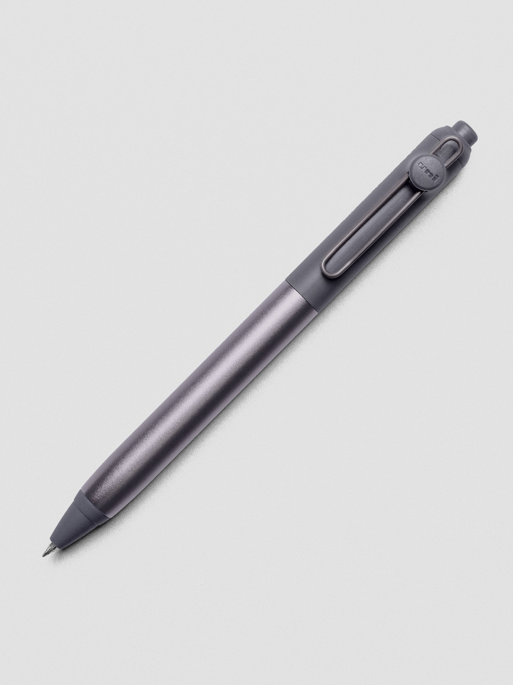 Grey pen shown at an angle on a grey background.