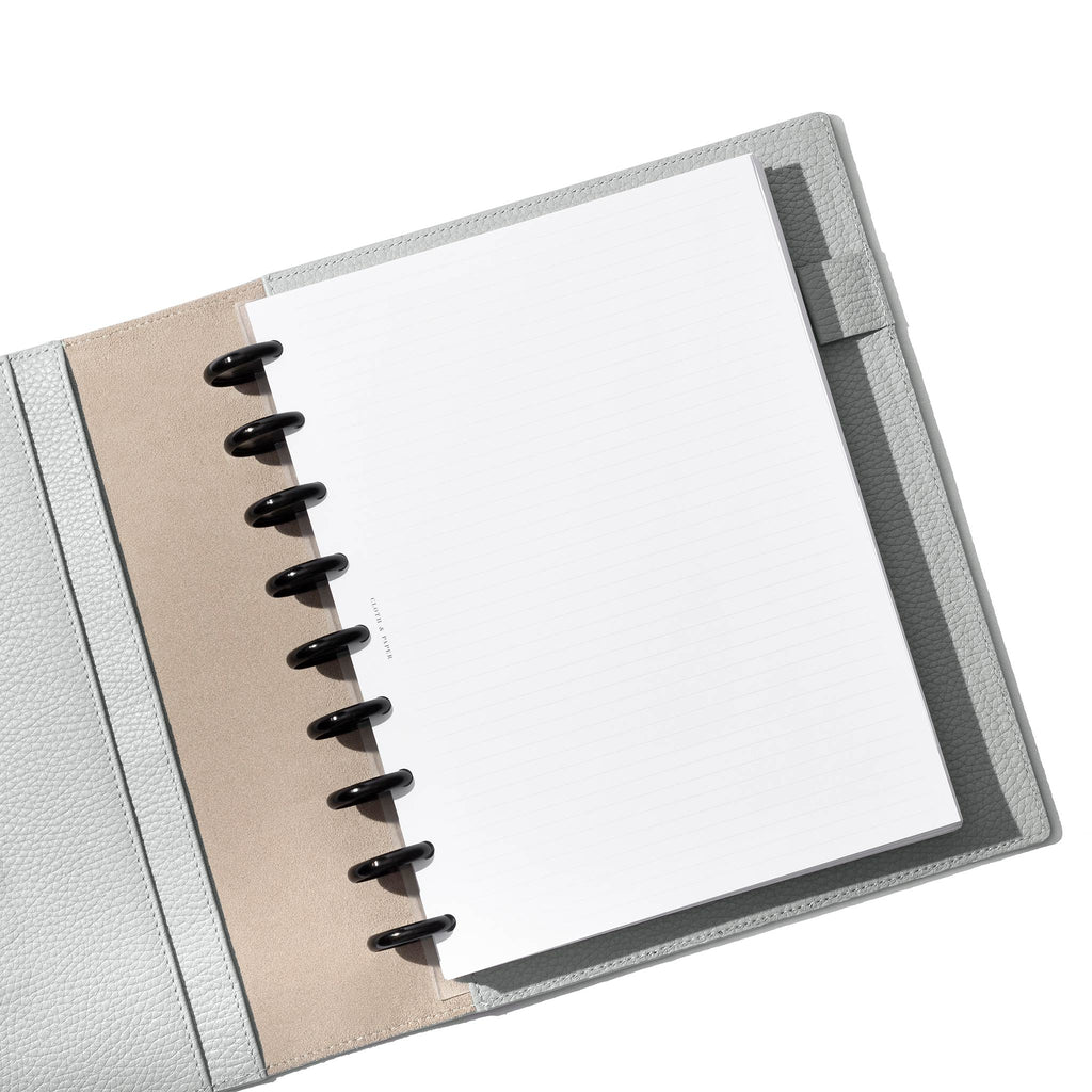 Veleta folio displayed with a discbound planner system inside of it on a white background.