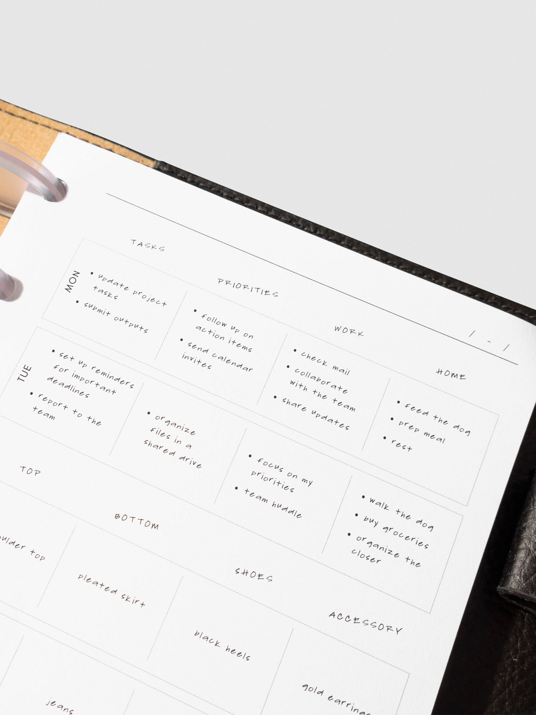 Closeup of insert in use inside a black leather planner.