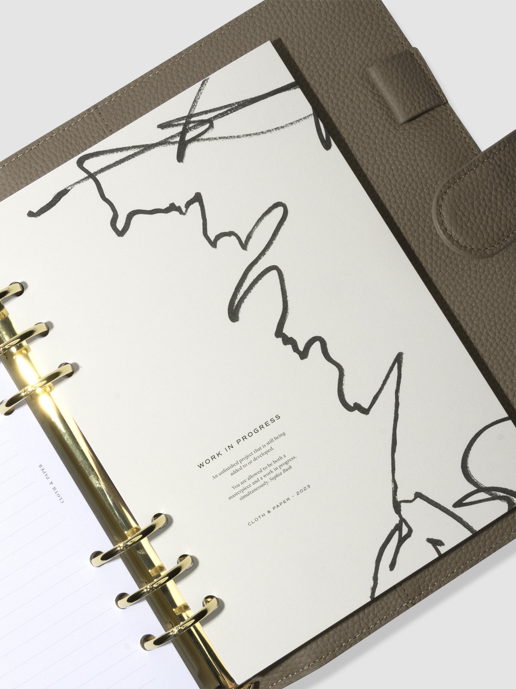 A5 planner with gold rings in a brown leather agenda featuring the work in progress planner dashboard.