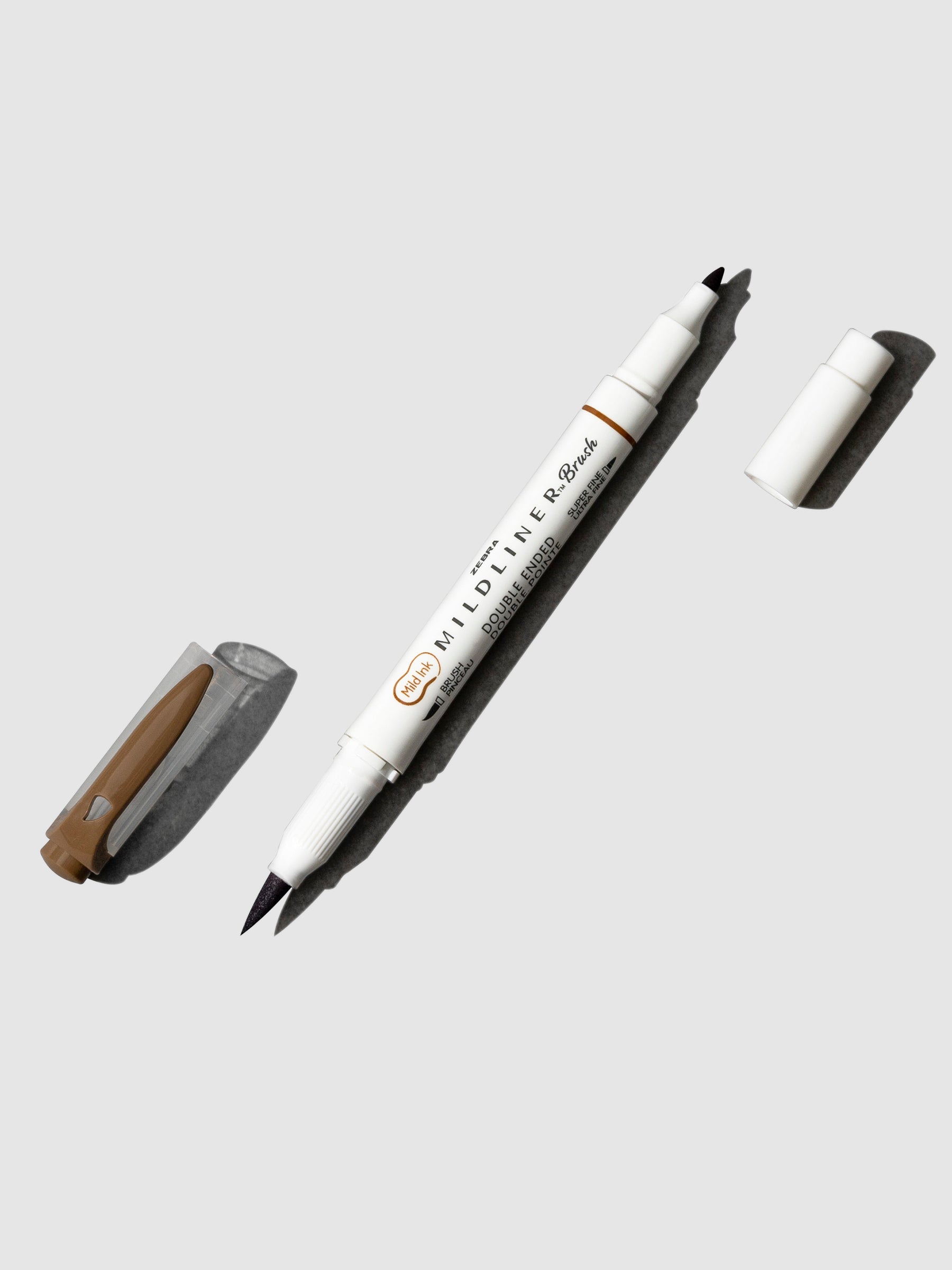 Zebra Mildliner Dual Tip Brush Pen in Brown displayed with caps removed from both ends. Pen is turned to the right against a neutral background.