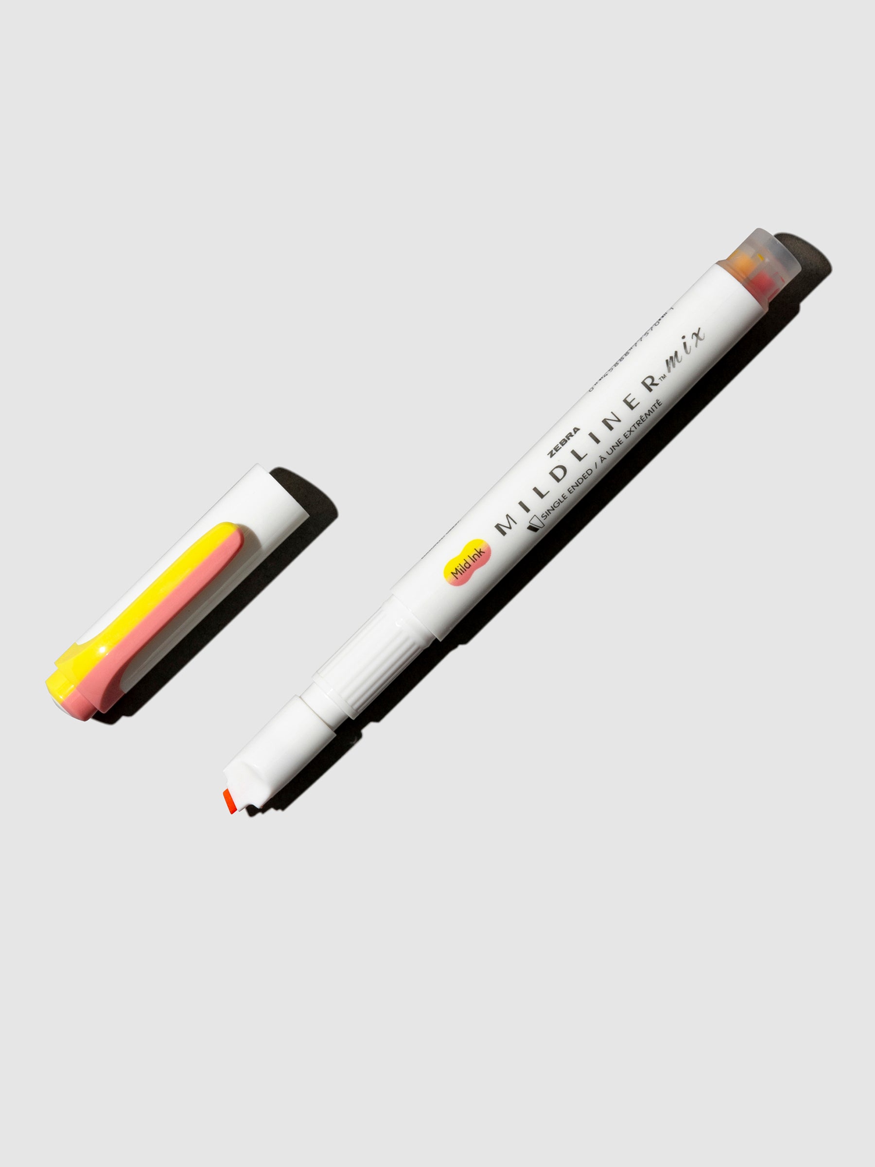 Zebra Mildliner Mix Highlighter, Cloth and Paper. Highlighter shown on a neutral background. Color shown is Coral Pink + Lemon Yellow.