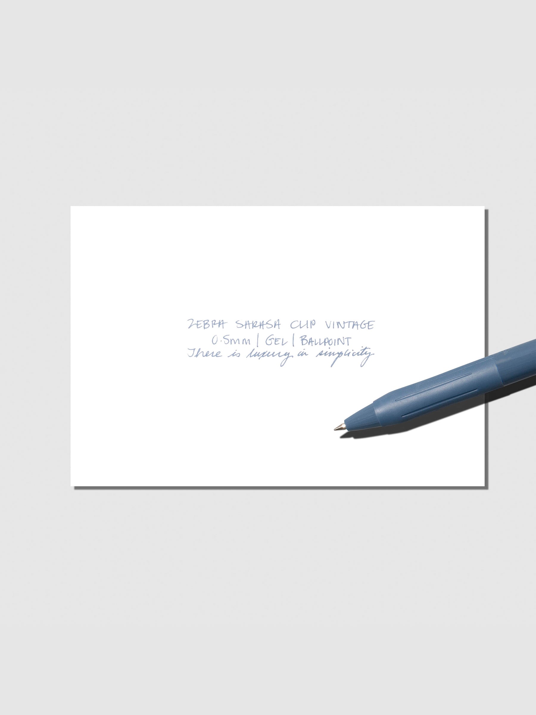 Pen testing sheet displayed with pen on a neutral background. Color shown is Blue Grey.