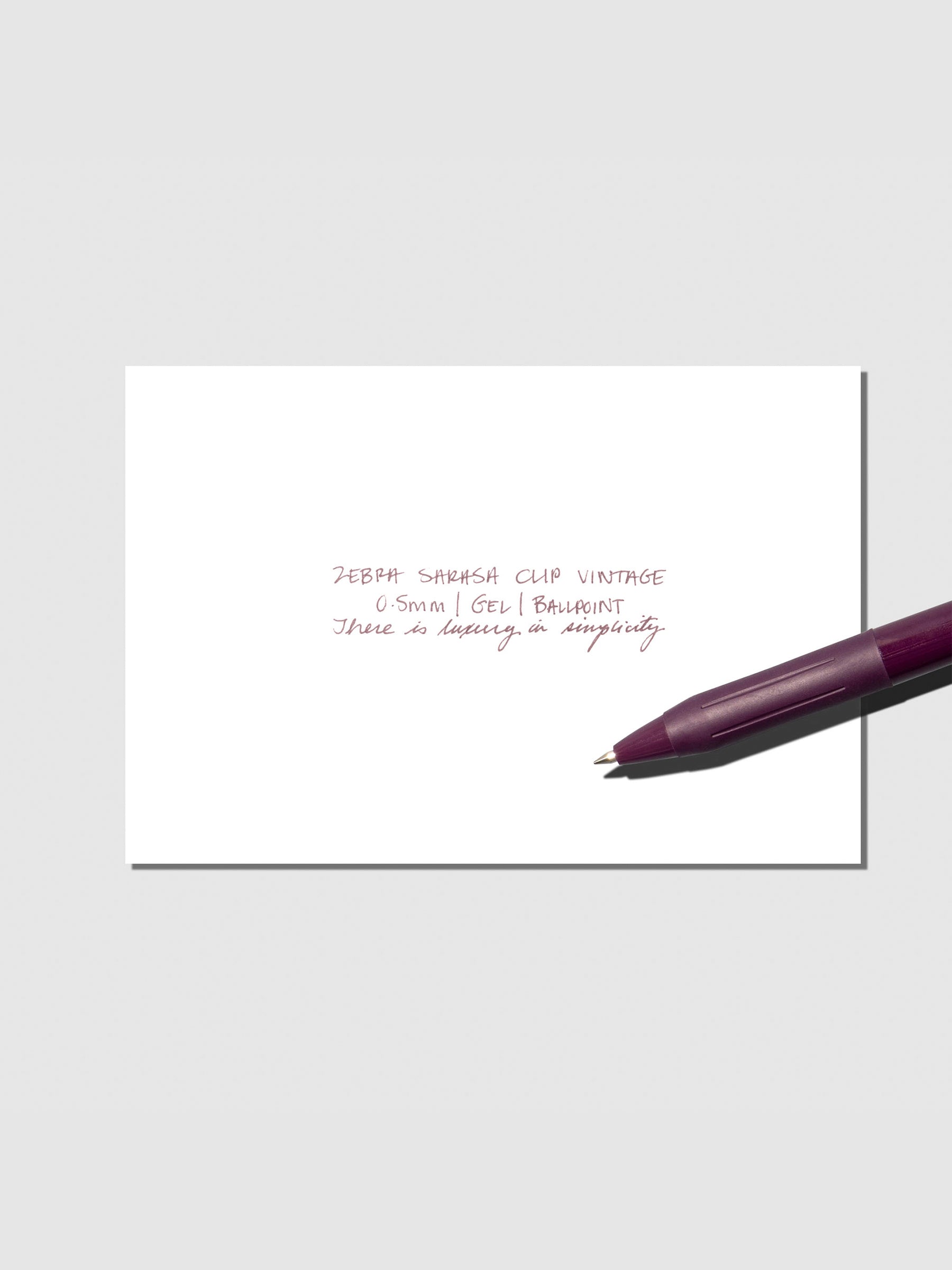 Pen testing sheet displayed with pen on a neutral background. Color shown is Bordeaux Purple.
