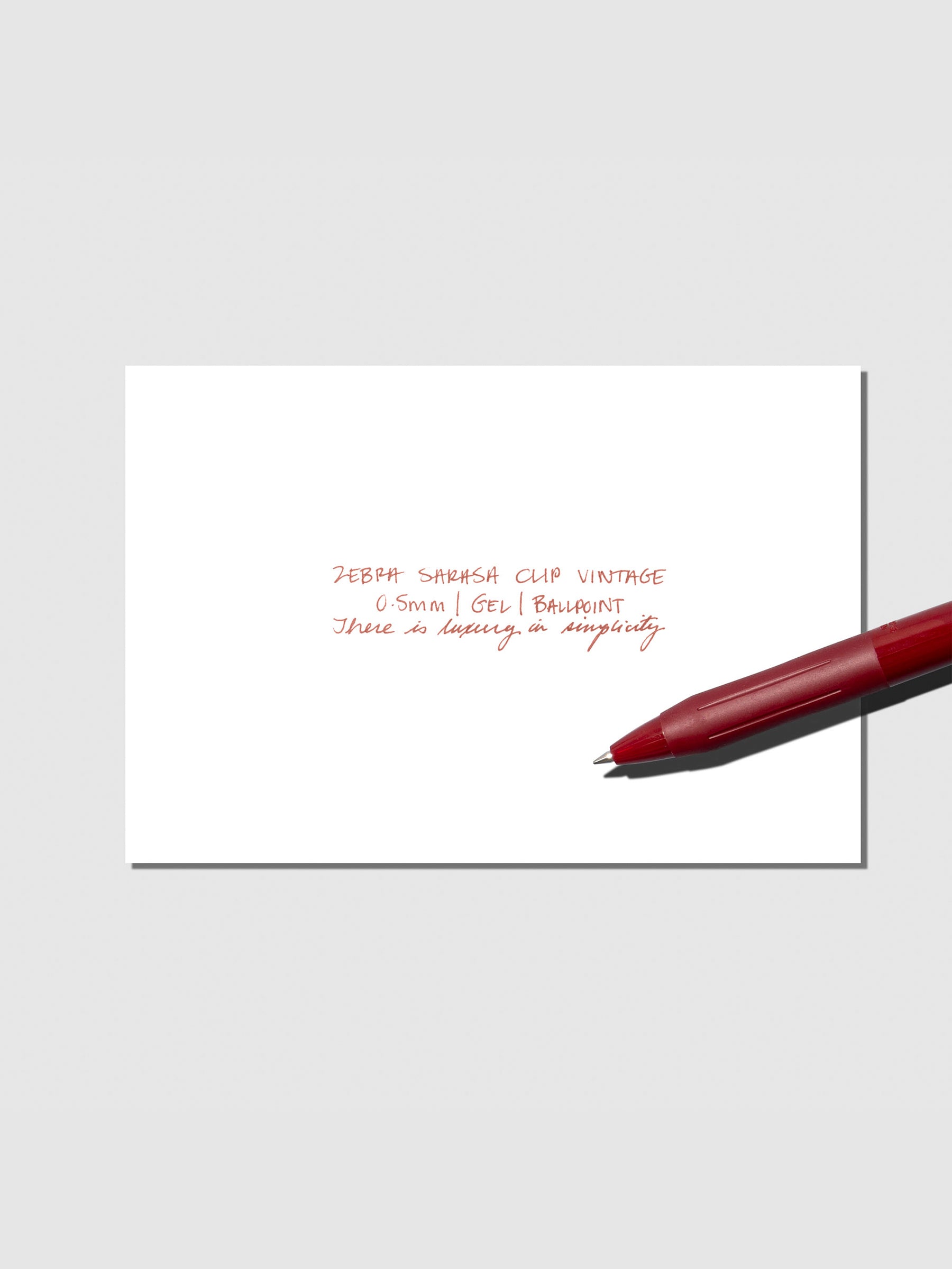 Pen testing sheet displayed with pen on a neutral background. Color shown is Red Black.